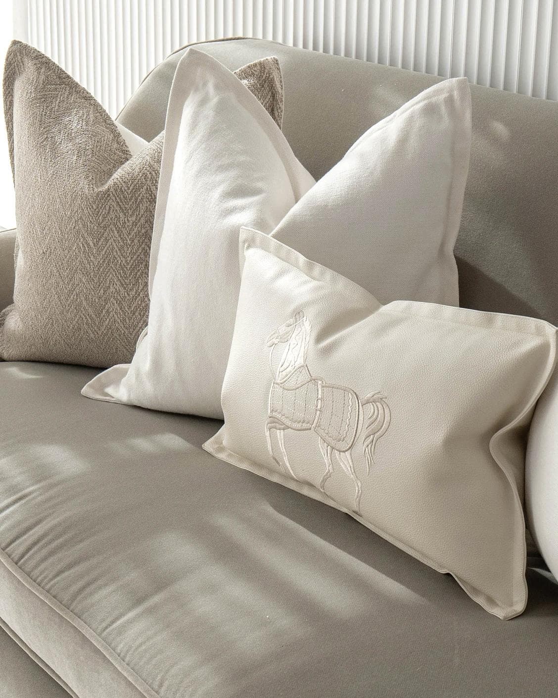 Antonio Bundle cushion in white and beige, shown in a lifestyle right view as image 5