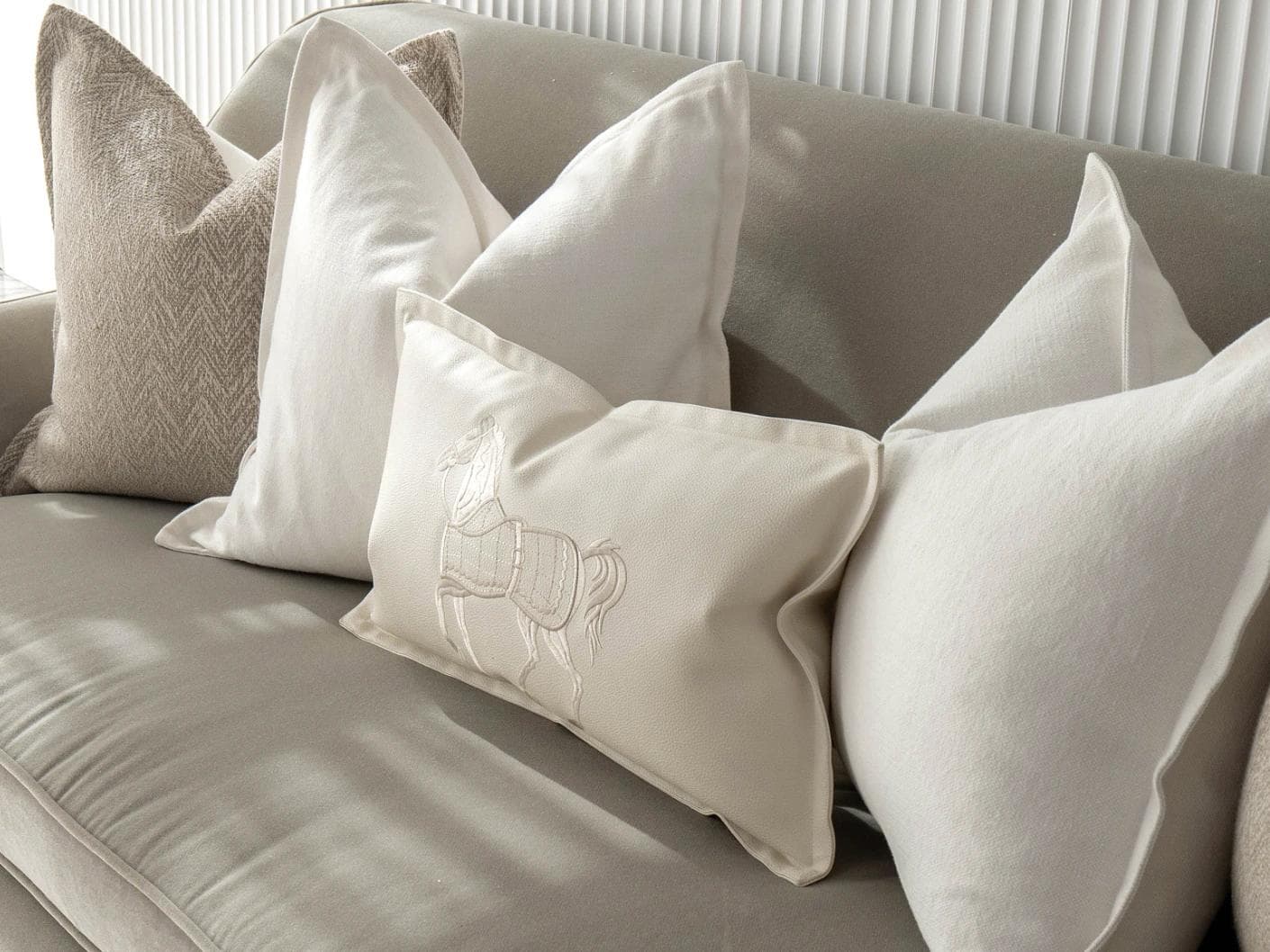 Antonio Bundle cushion in white and beige, shown in a lifestyle right view as image 5