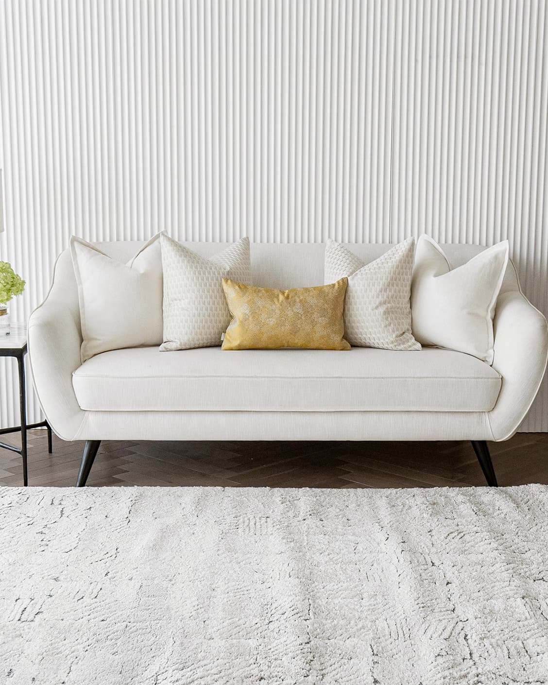 Melina Bundle cushion in white, yellow and beige, shown in a lifestyle front view as image 4