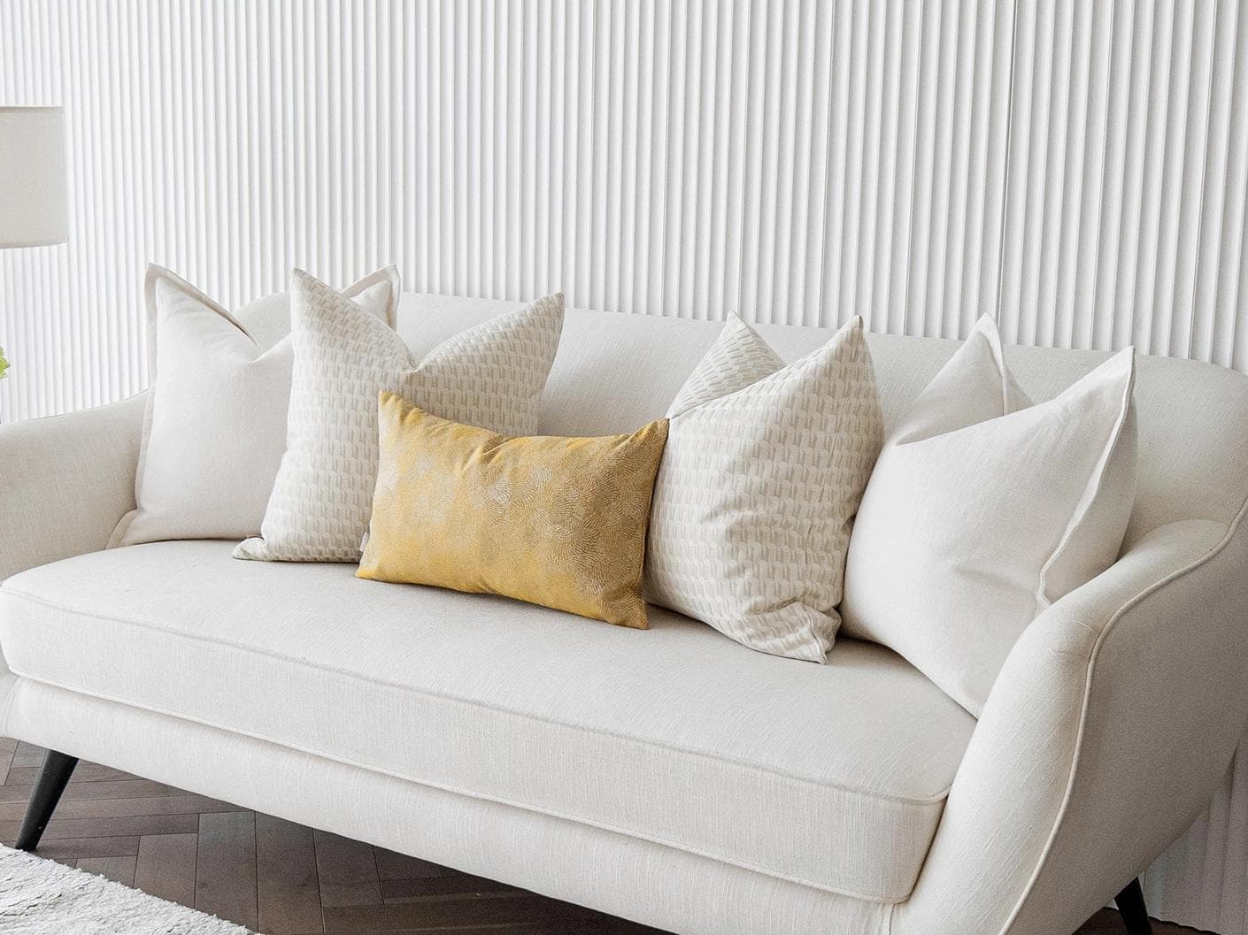 Melina Bundle cushion in white, yellow and beige, shown in a lifestyle right view as image 2