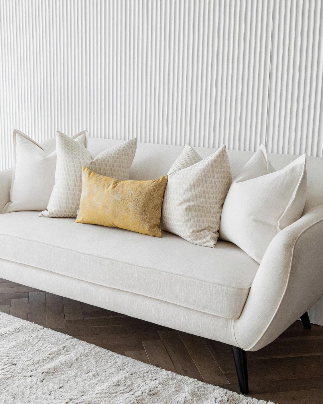 Melina Bundle cushion in white, yellow and beige, shown in a lifestyle right view as image 2