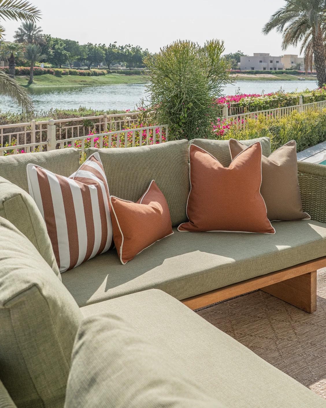 Pranvi Bundle cushion in rust and brown, shown in a lifestyle left view as image 2