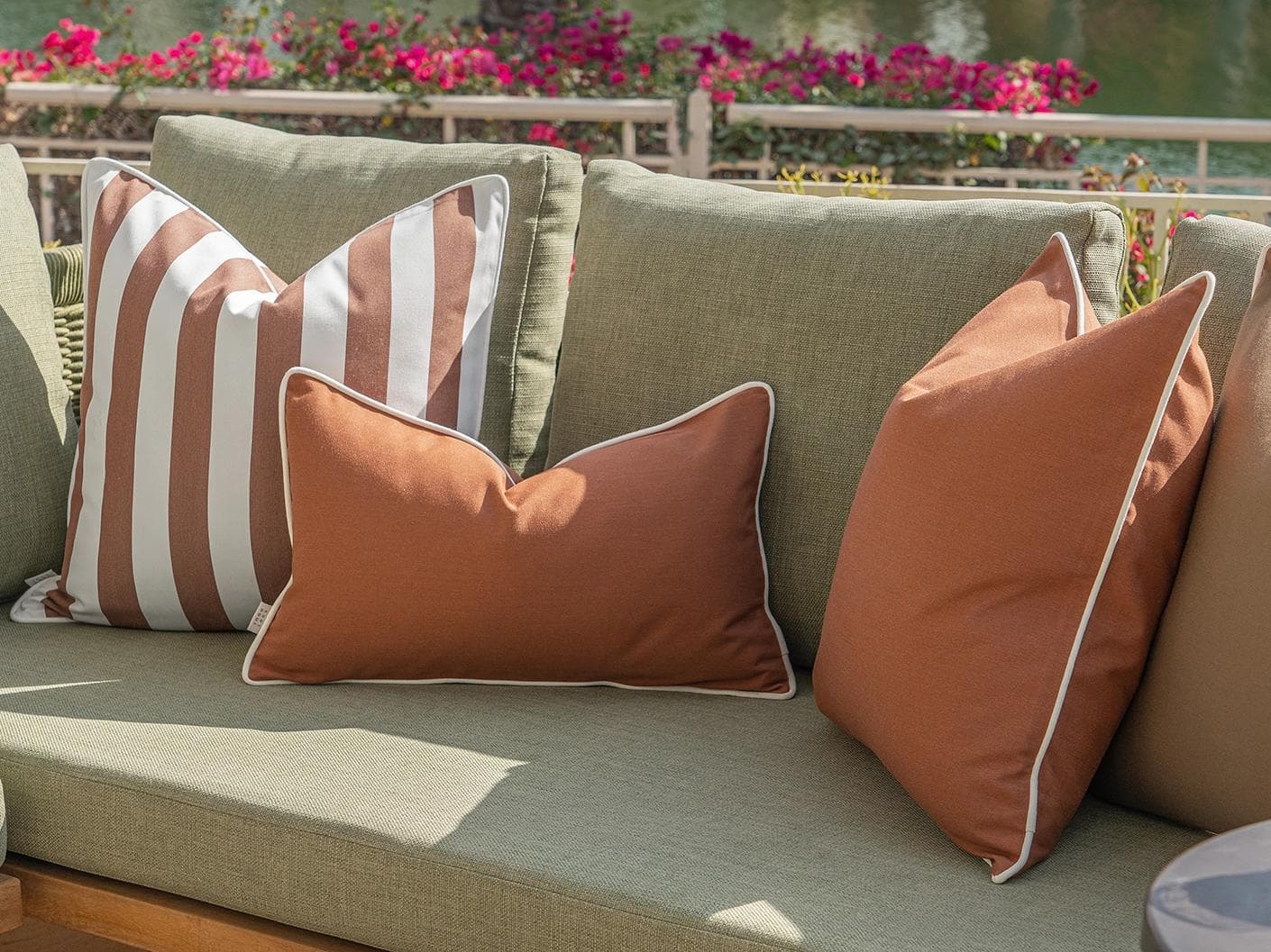 Pranvi Bundle cushion in rust and brown, shown in a lifestyle right view as image 8