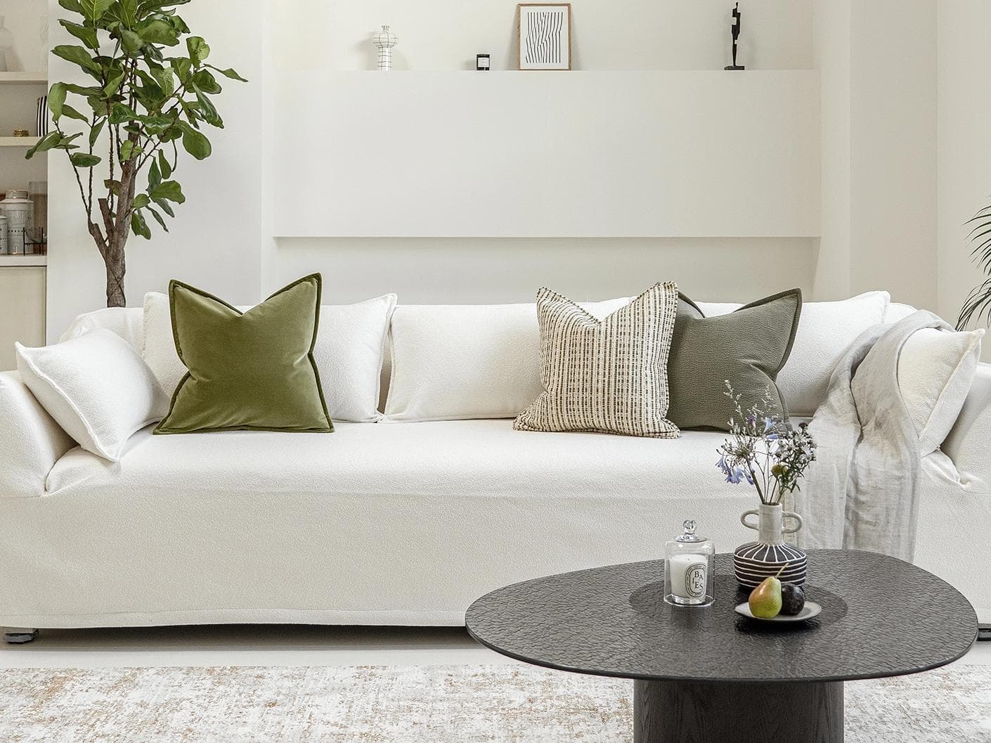 Praveen Bundle cushion in green and cream, shown in a lifestyle front view as image 4