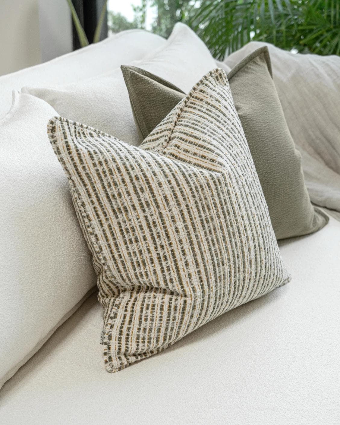Praveen Bundle cushion in green and cream, shown in a product left view as image 6