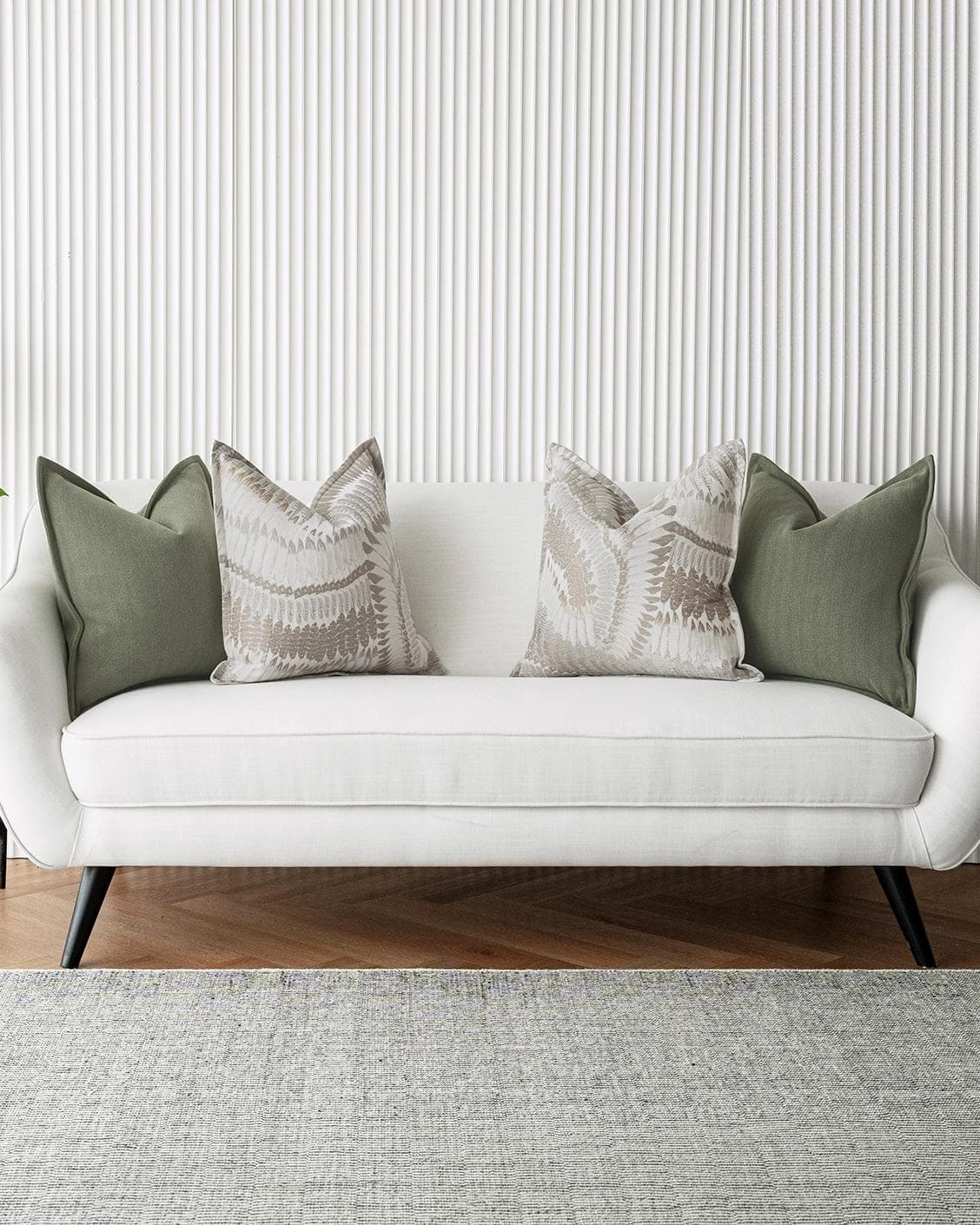Quentin Bundle cushion in green, brown and grey, shown in a lifestyle front view as image 4