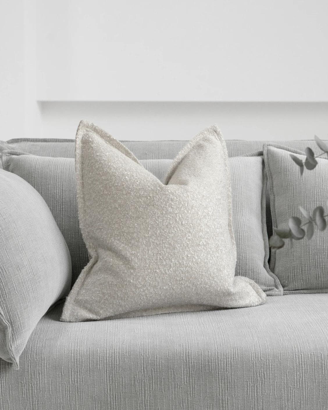 Quinn Shale cushion in cream and beige, shown in a lifestyle front view as image 2