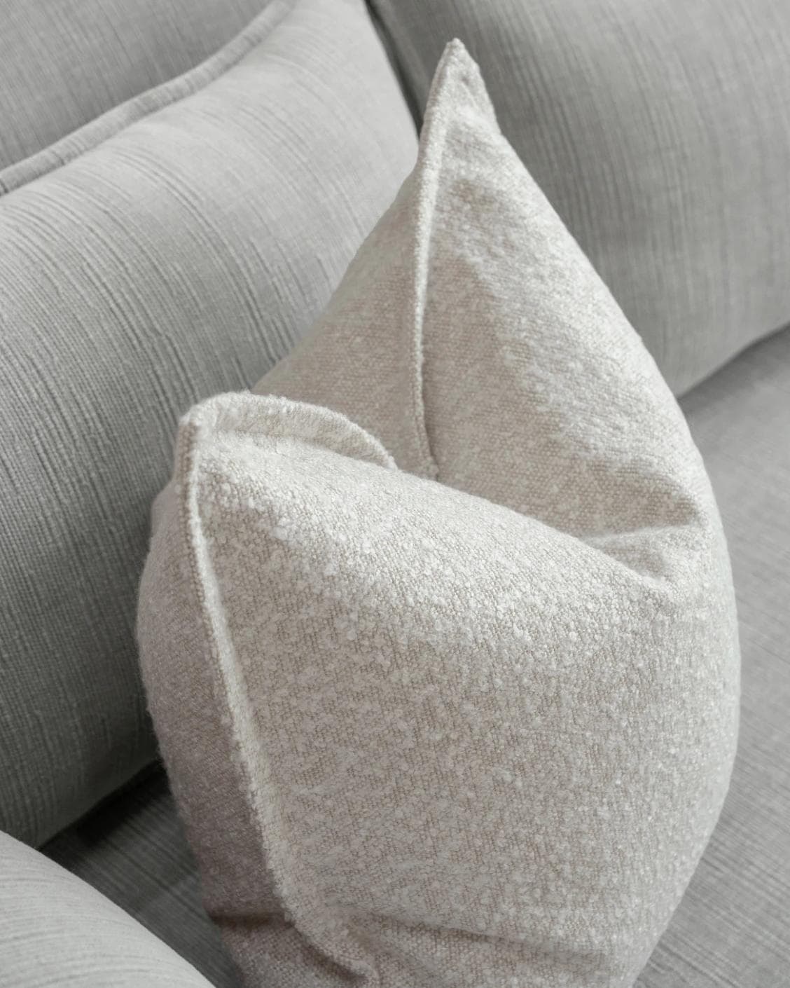 Quinn Shale cushion in cream and beige, shown in a lifestyle top view as image 5