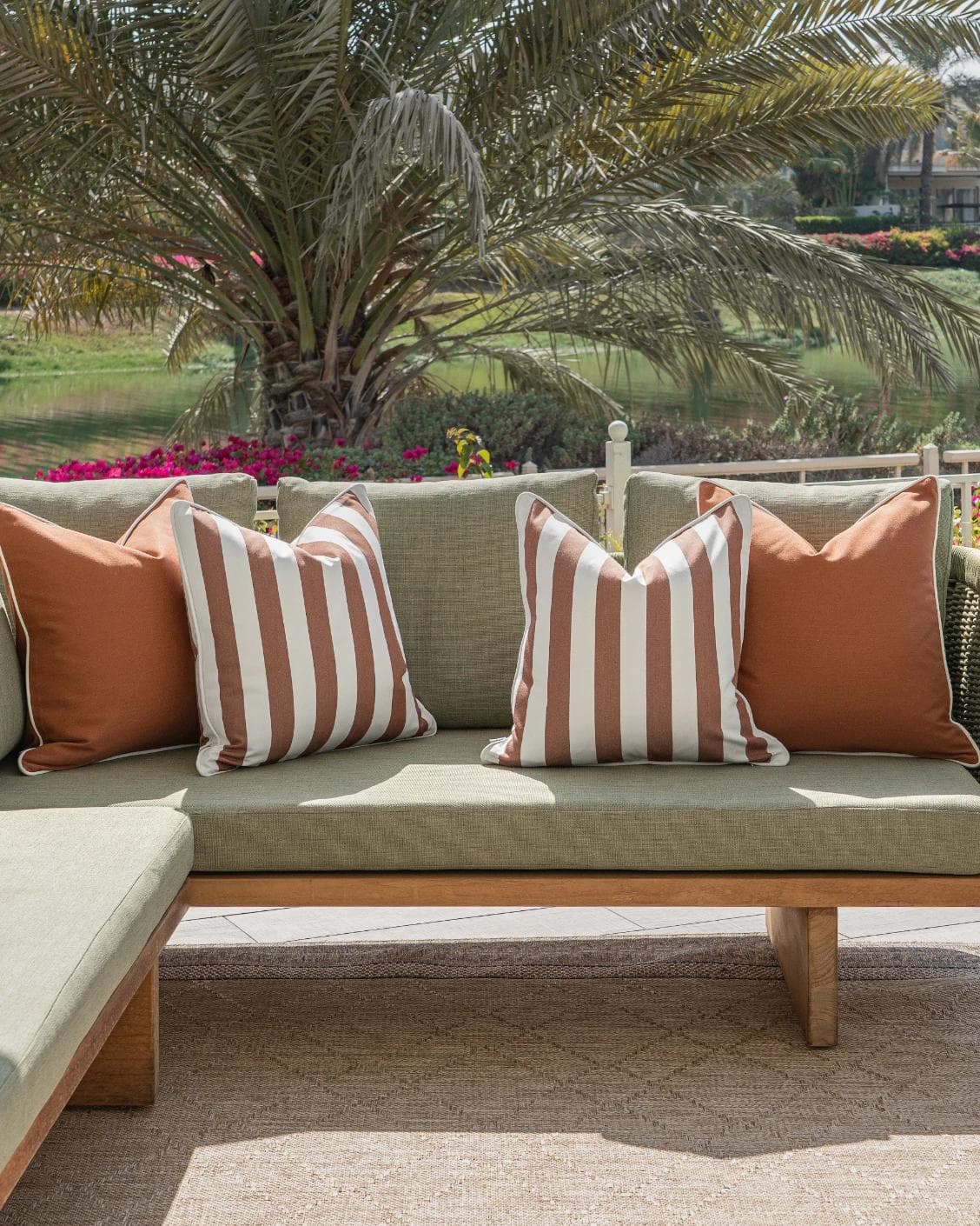 Raha Bundle cushion in rust, shown in a lifestyle front view as image 4