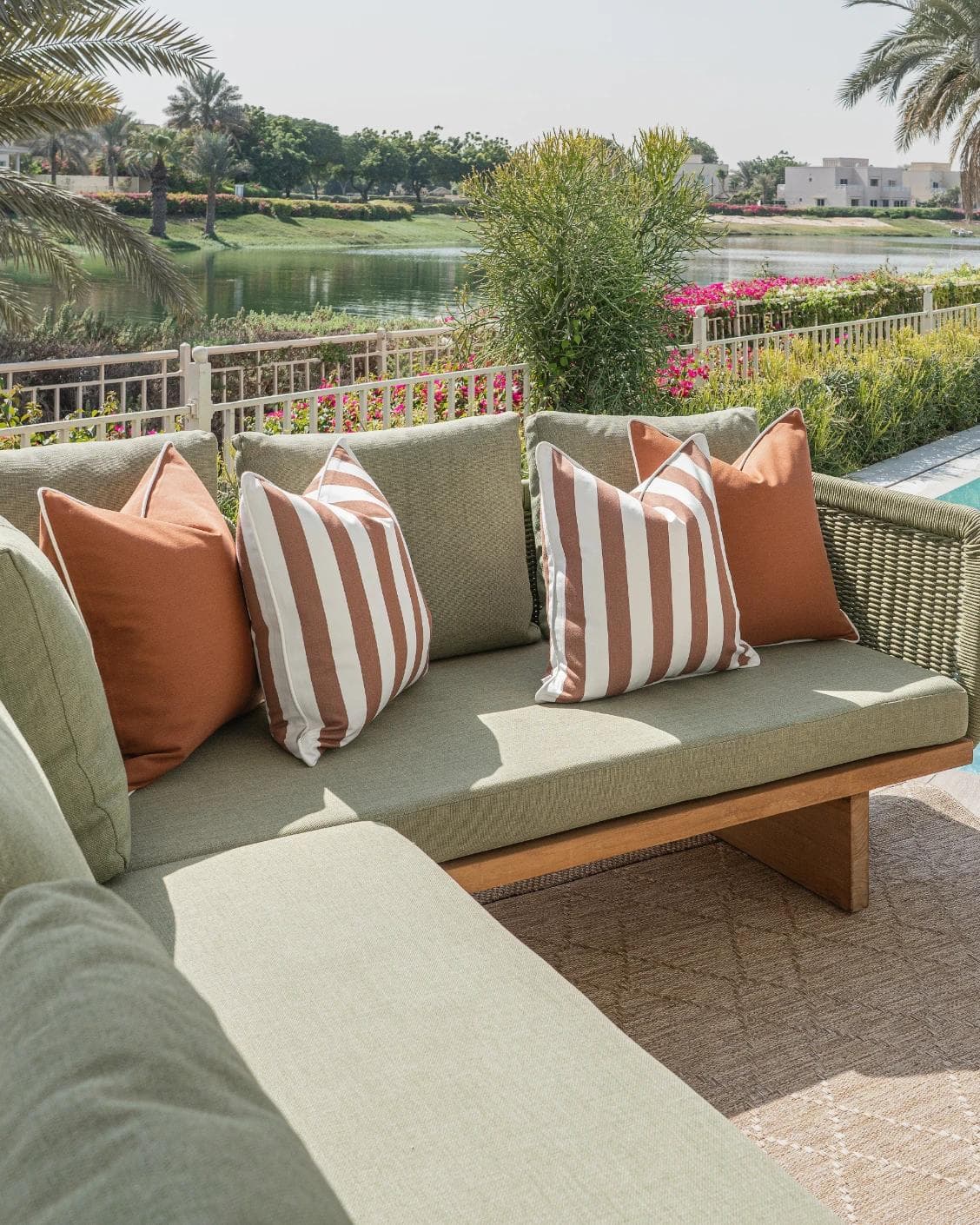 Raha Bundle cushion in rust, shown in a lifestyle left view as image 2