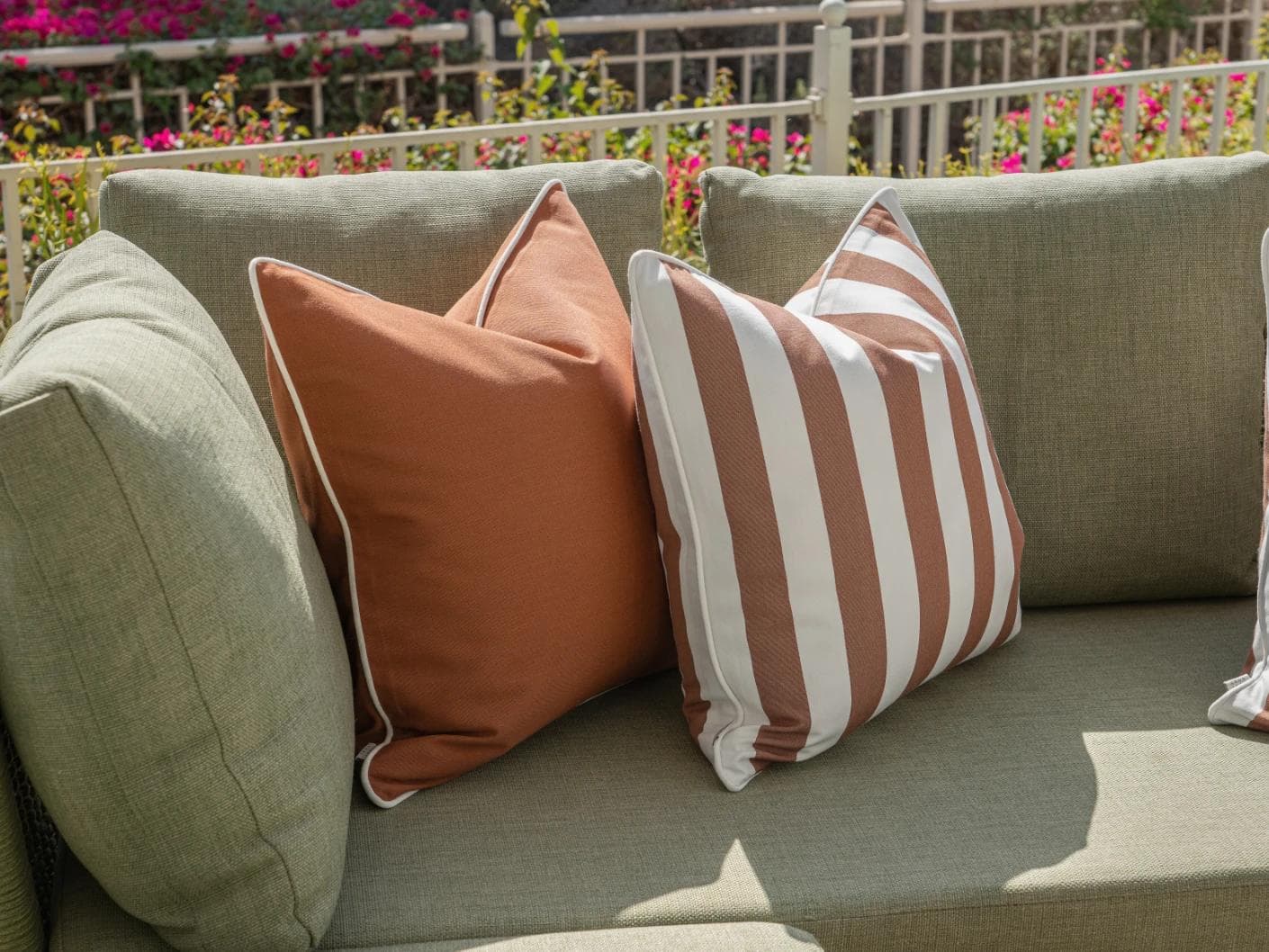 Raha Bundle cushion in rust, shown in a lifestyle left view as image 5