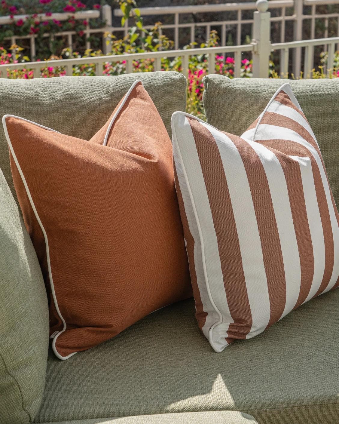 Raha Bundle cushion in rust, shown in a lifestyle left view as image 5