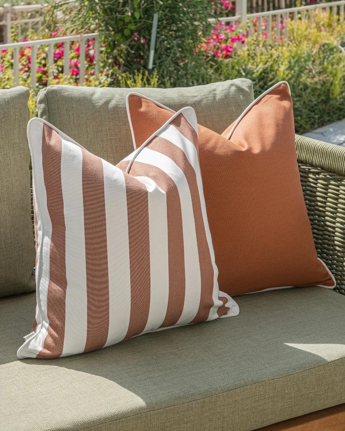 Raha Bundle cushion in rust, shown in a lifestyle left view as image 6