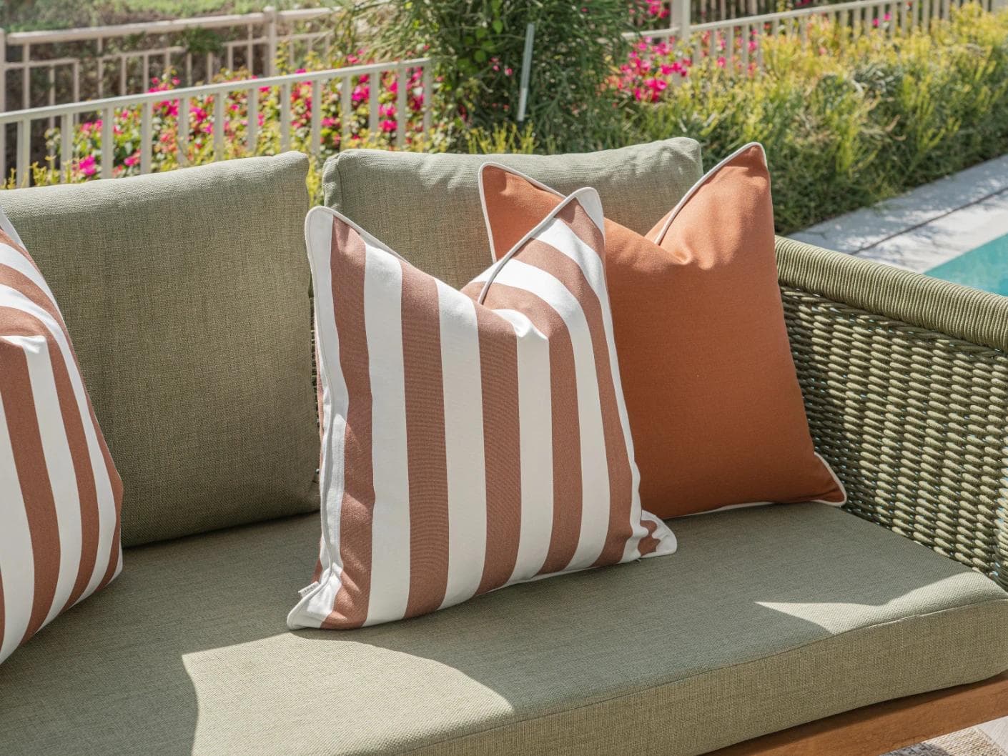 Raha Bundle cushion in rust, shown in a lifestyle left view as image 6