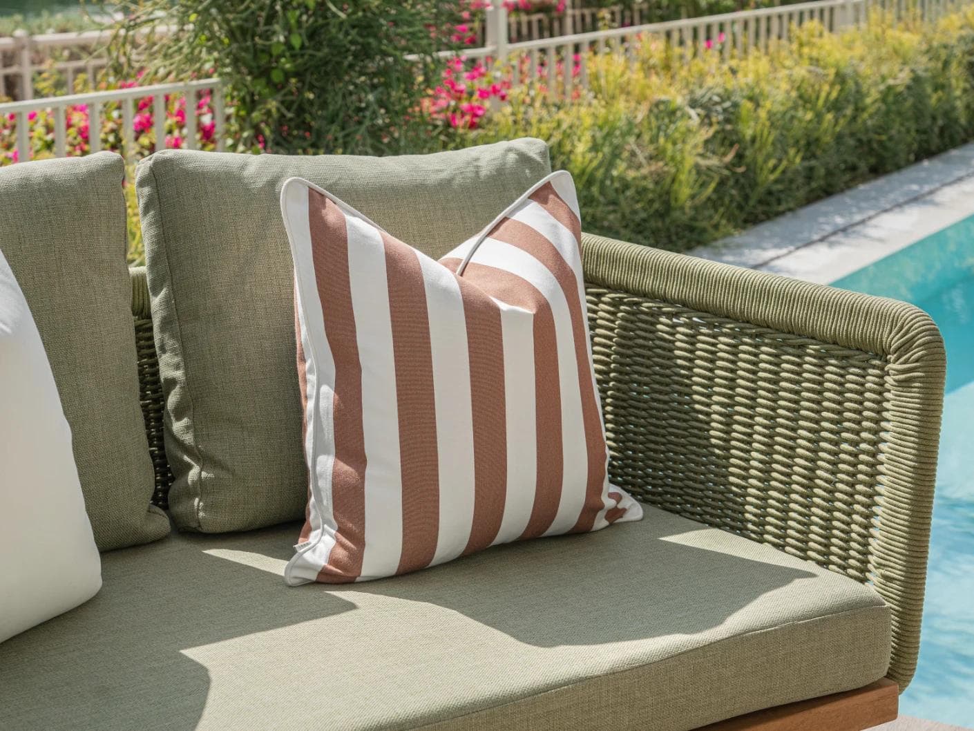 Raha Bundle cushion in rust, shown in a lifestyle left view as image 7