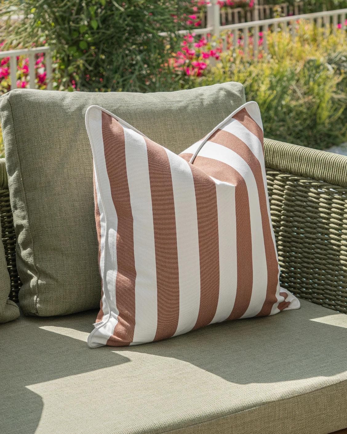 Raha Bundle cushion in rust, shown in a lifestyle left view as image 7