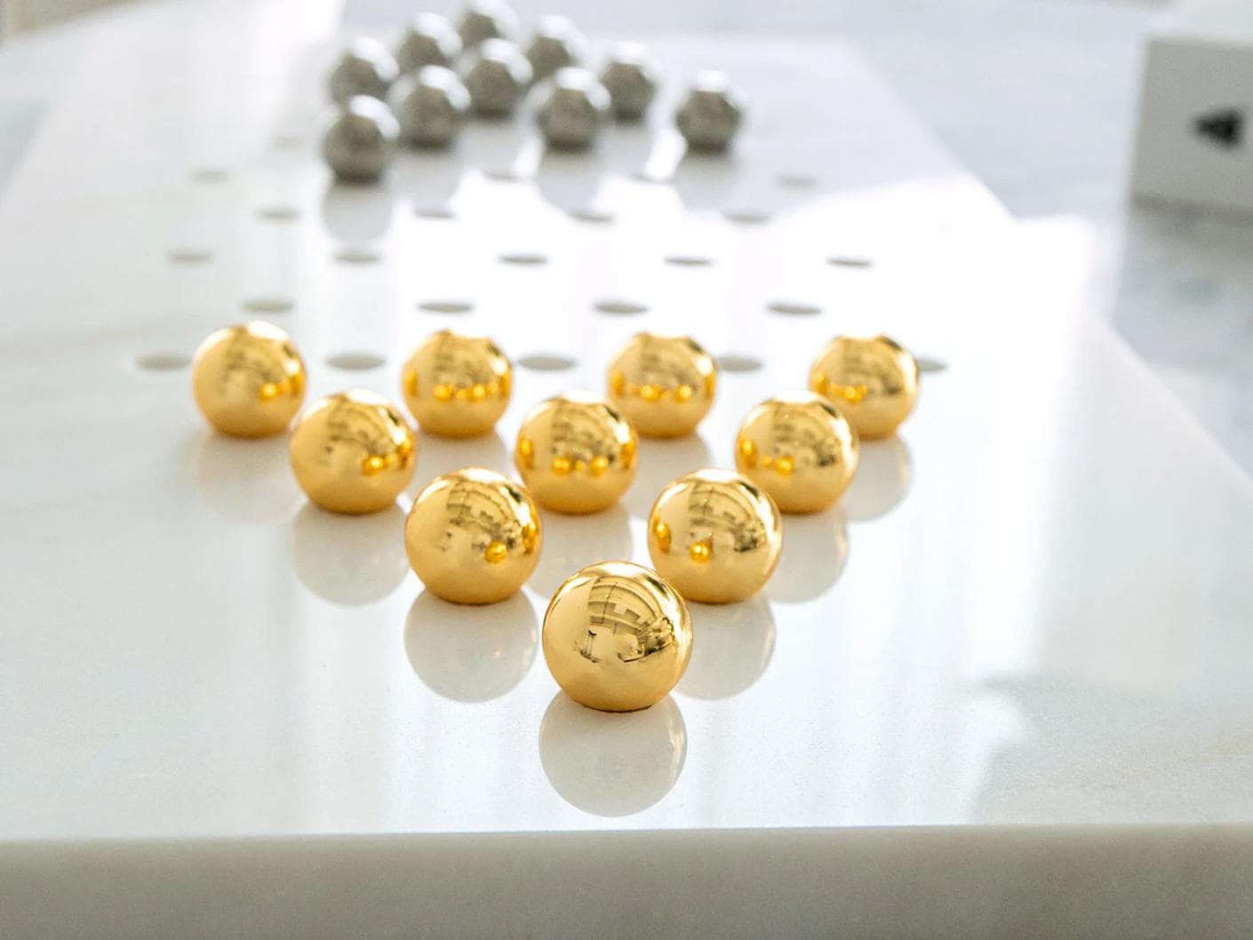 Rally Malcolm statues and sculptures in gold, white and silver, shown in a lifestyle close-up as image 4