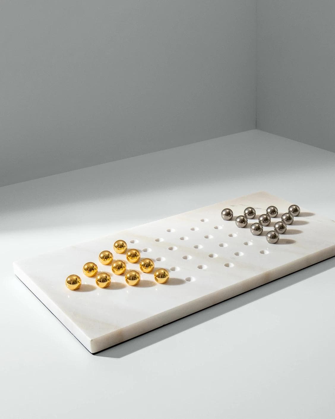 Rally Malcolm statues and sculptures in gold, white and silver, shown in a lifestyle left view as image 5