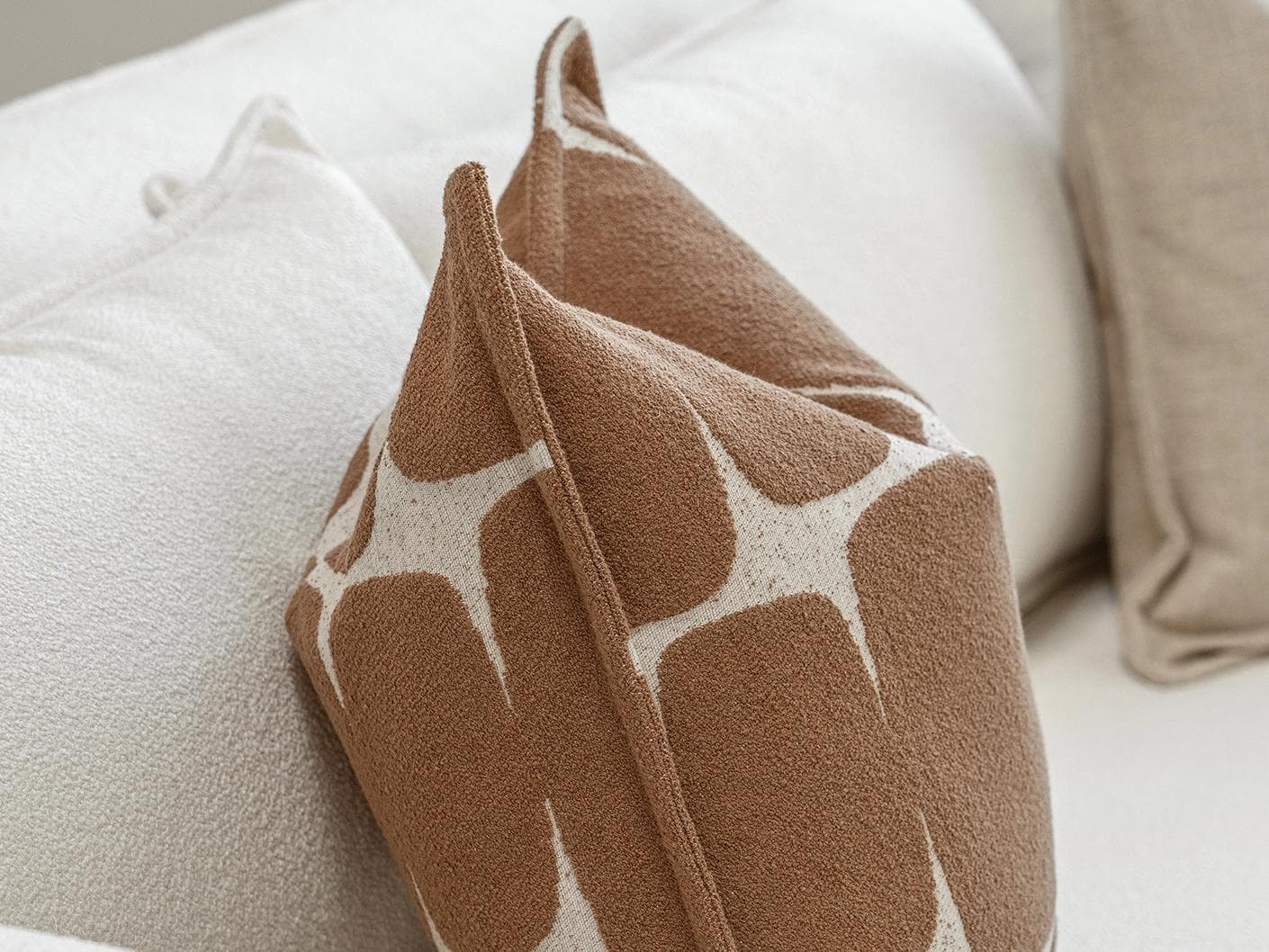 Ranjith Bundle cushion in beige and brown, shown in a product left view as image 6