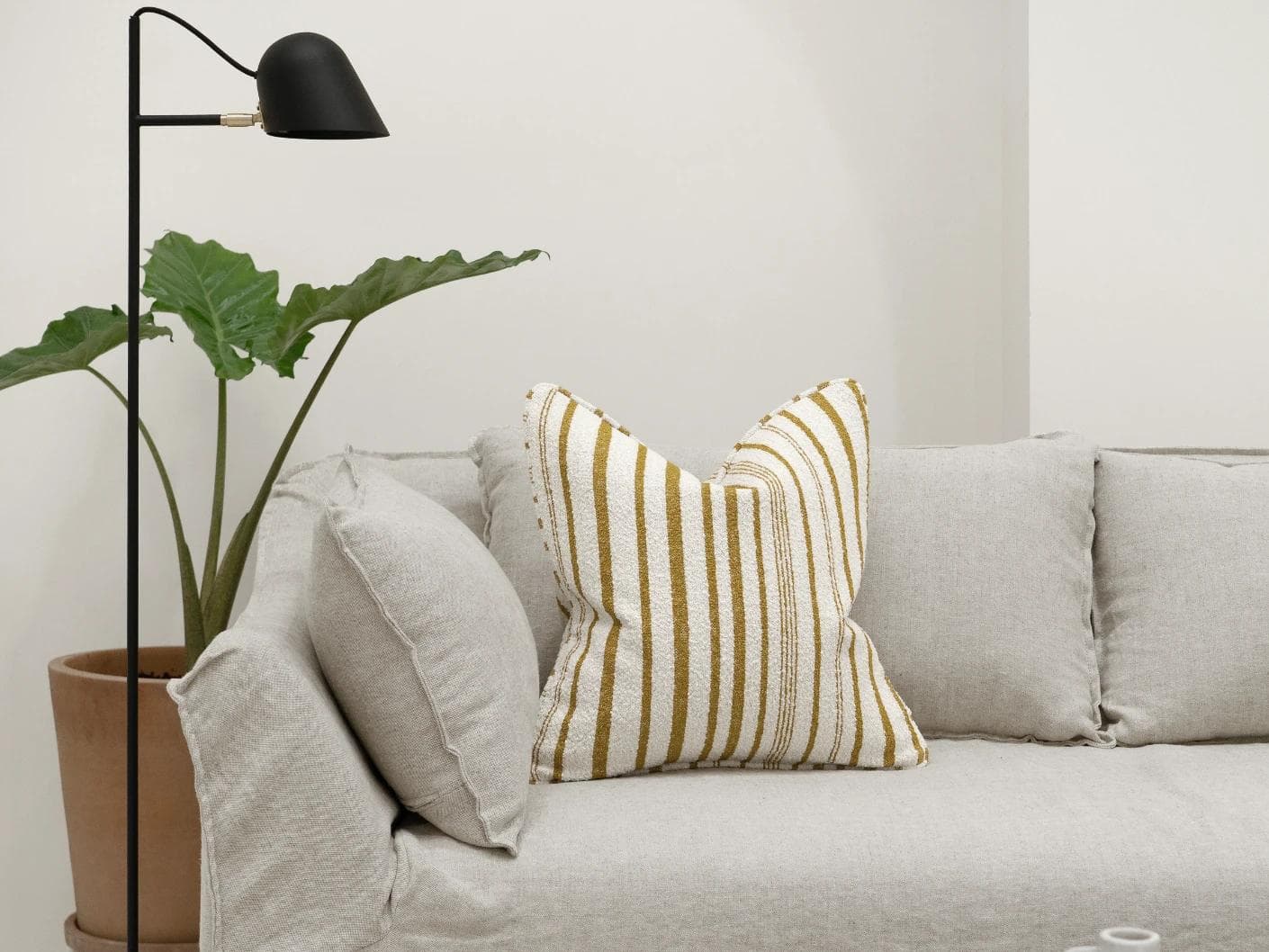 Raya Klimt cushion in ivory, shown in a lifestyle front view as image 4
