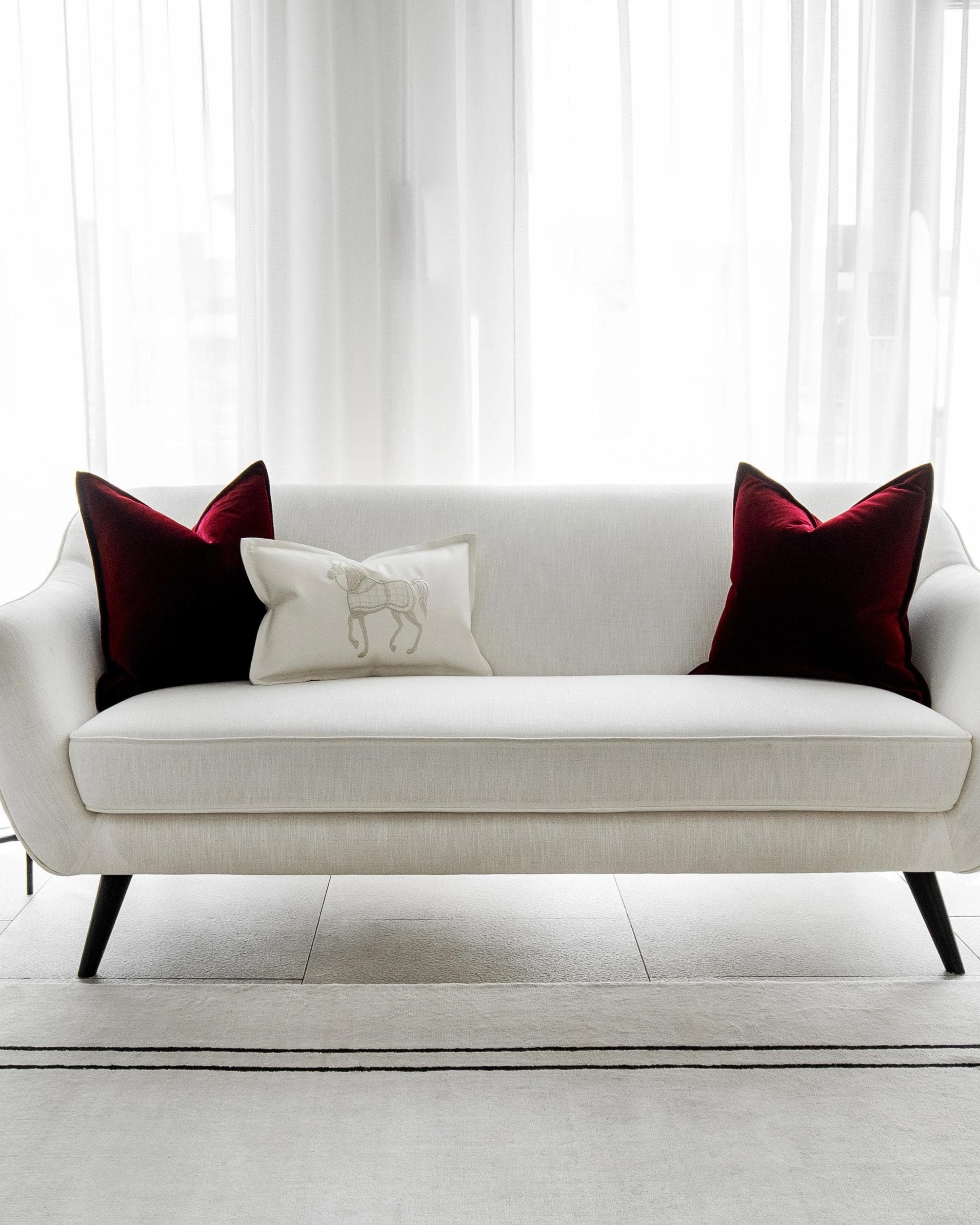 Garnet Bundle cushion in red, shown in a lifestyle front view as image 5