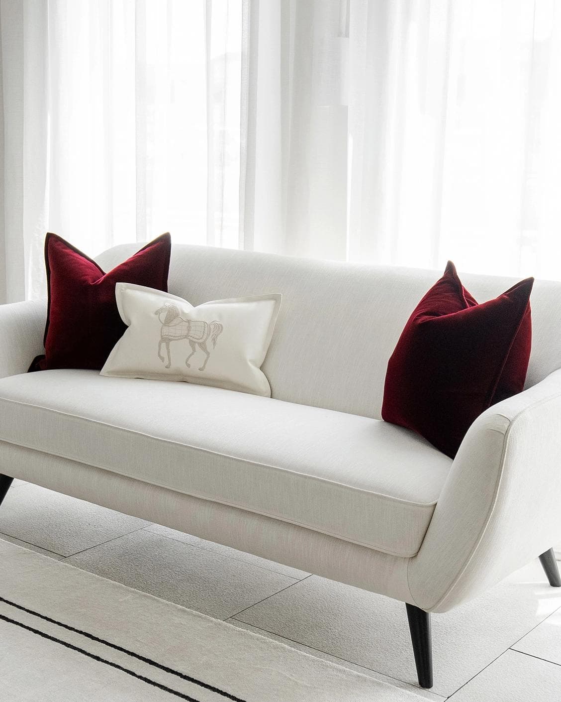 Garnet Bundle cushion in red, shown in a lifestyle right view as image 2