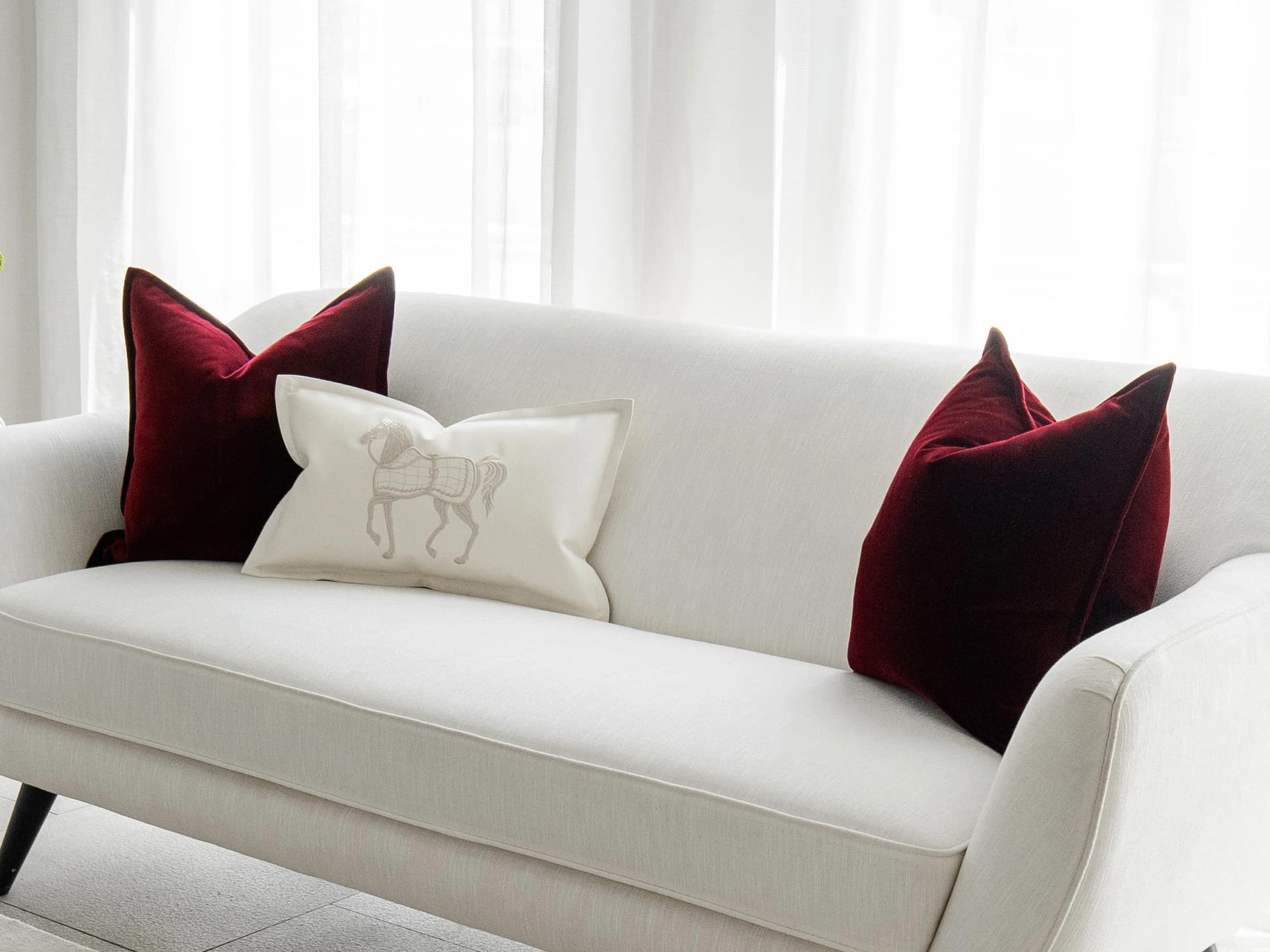 Garnet Bundle cushion in red, shown in a lifestyle right view as image 2