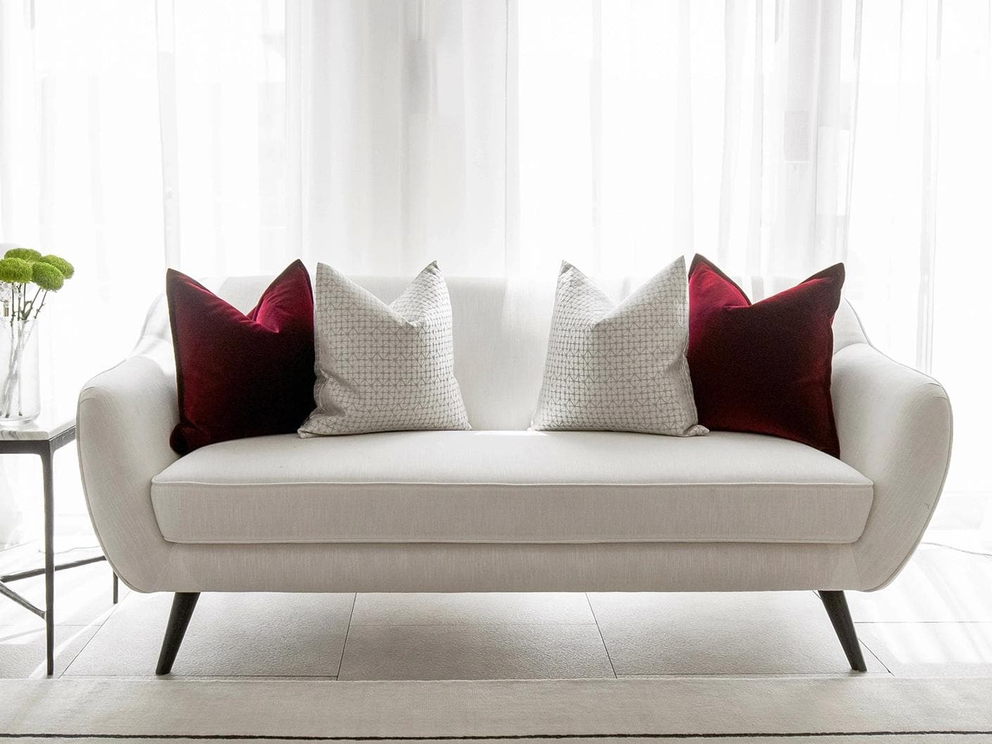 Cerise Bundle cushion in red, silver and white, shown in a lifestyle front view as image 4