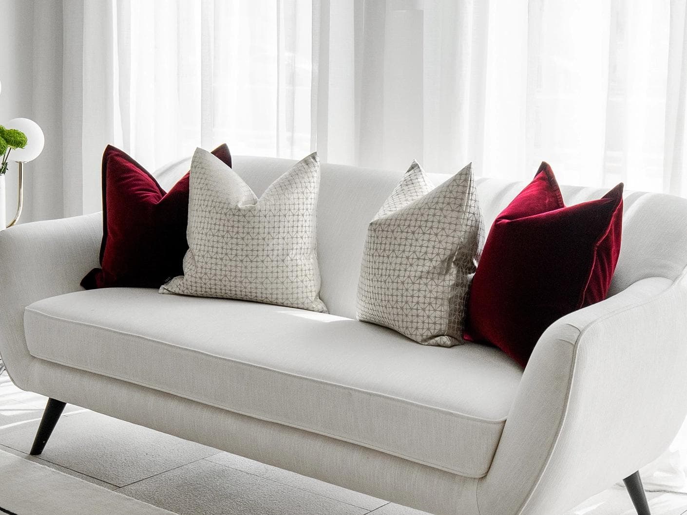 Cerise Bundle cushion in red, silver and white, shown in a lifestyle right view as image 2