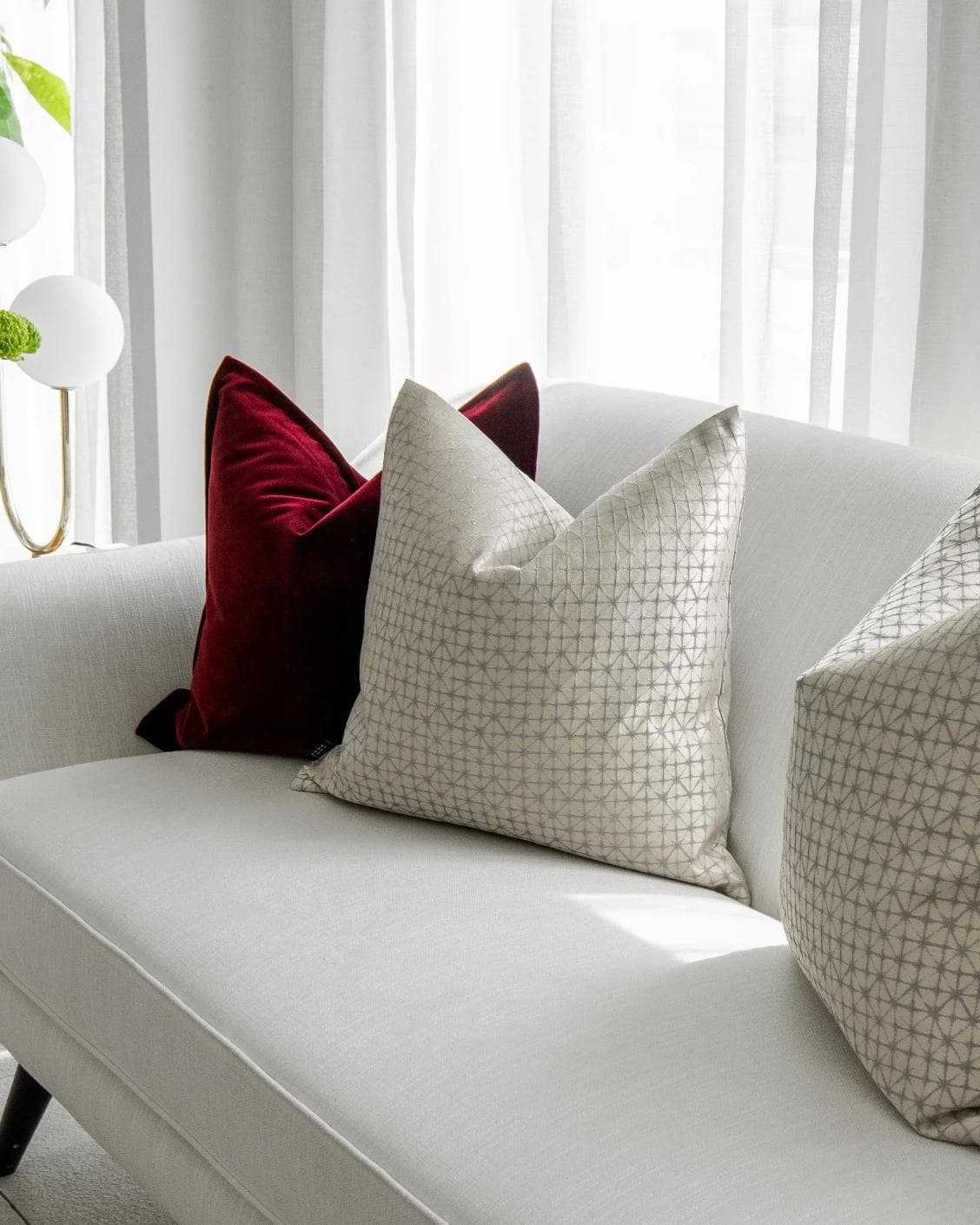 Cerise Bundle cushion in red, silver and white, shown in a lifestyle right view as image 5