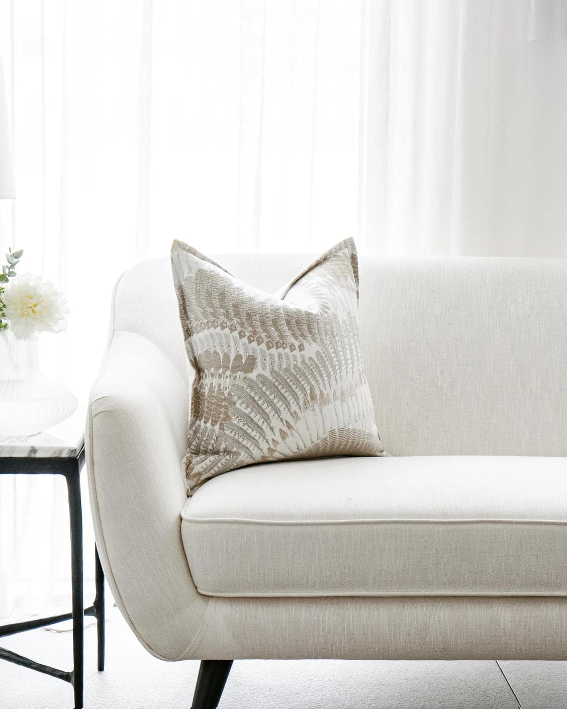 Reesha Bianca cushion in brown and grey, shown in a lifestyle front view as image 4