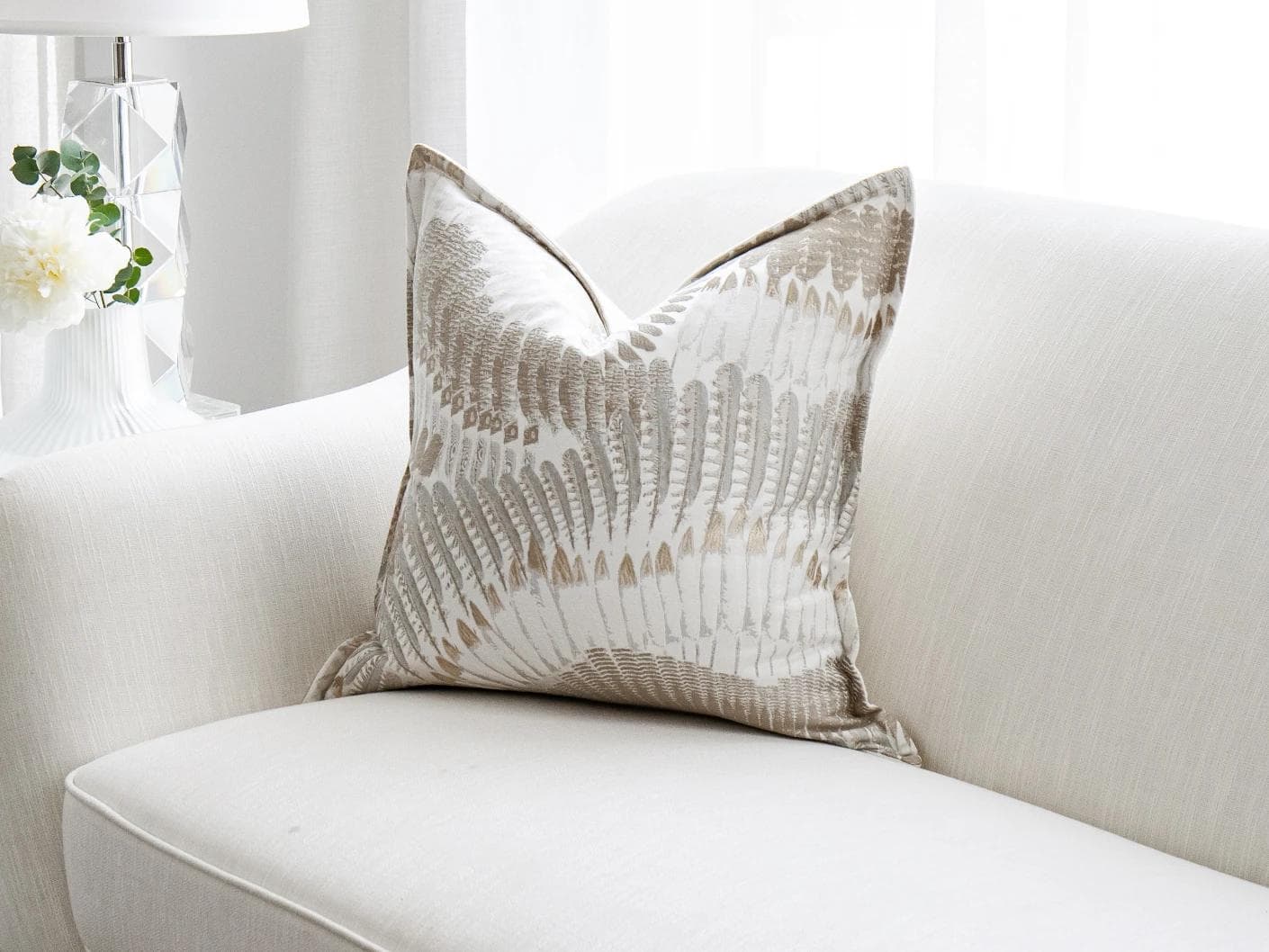 Reesha Bianca cushion in brown and grey, shown in a lifestyle front view as image 2