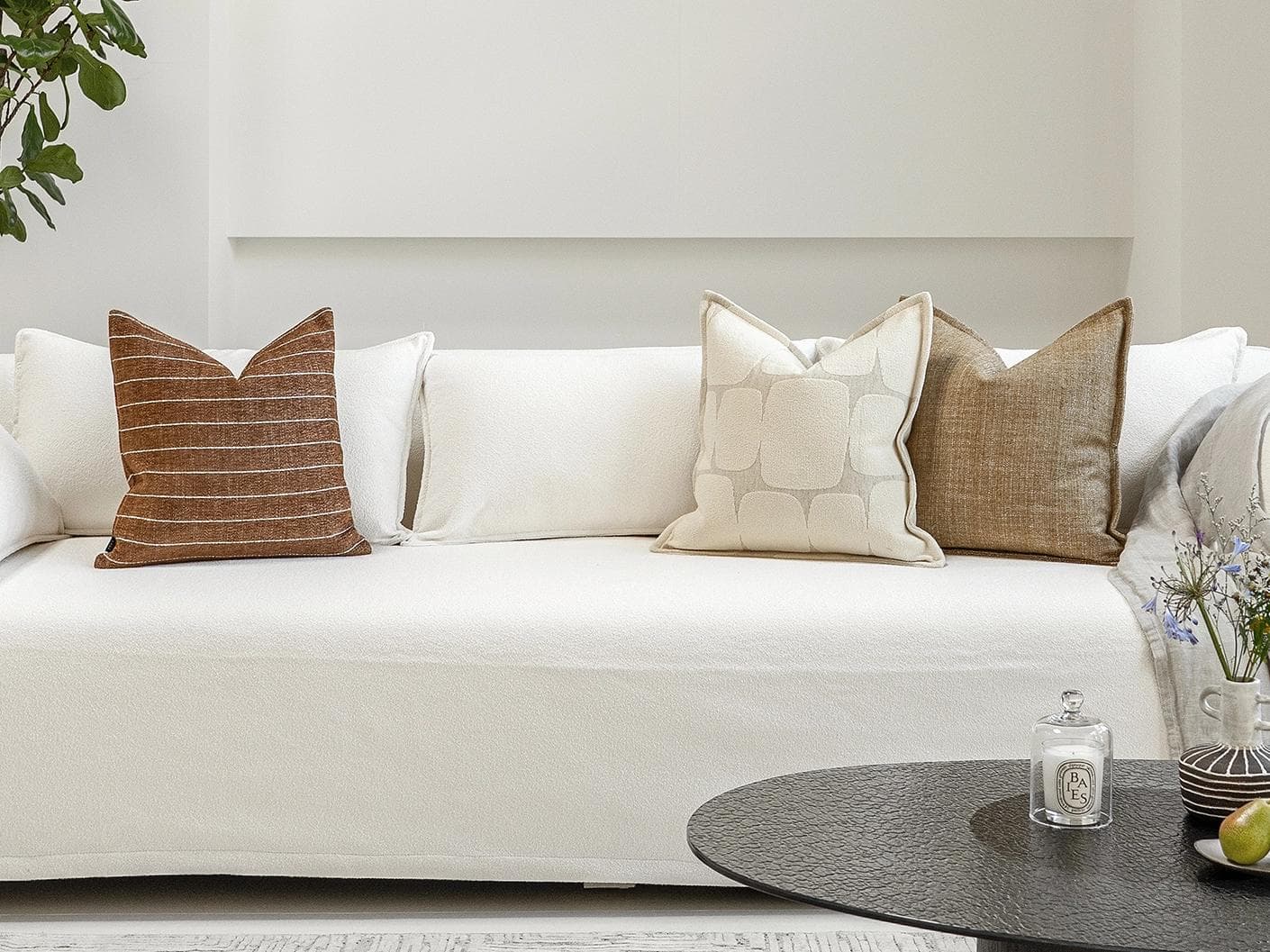 Rennie Bundle cushion in brown and white, shown in a lifestyle front view as image 4
