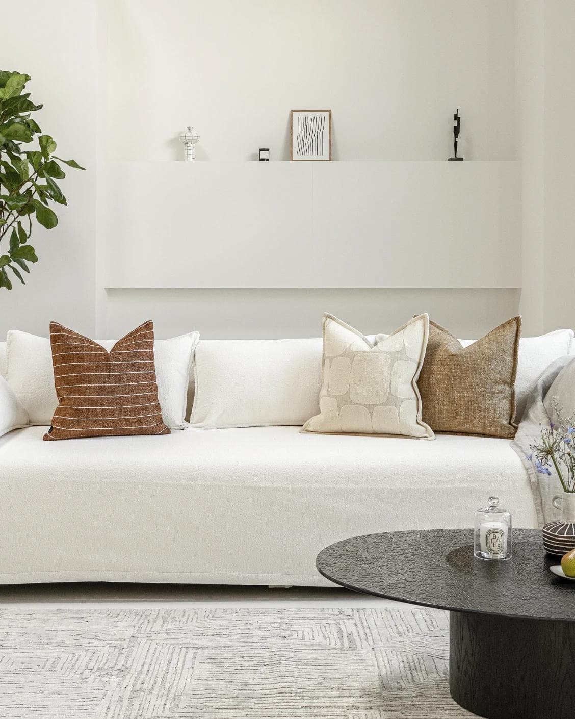 Rennie Bundle cushion in brown and white, shown in a lifestyle front view as image 4