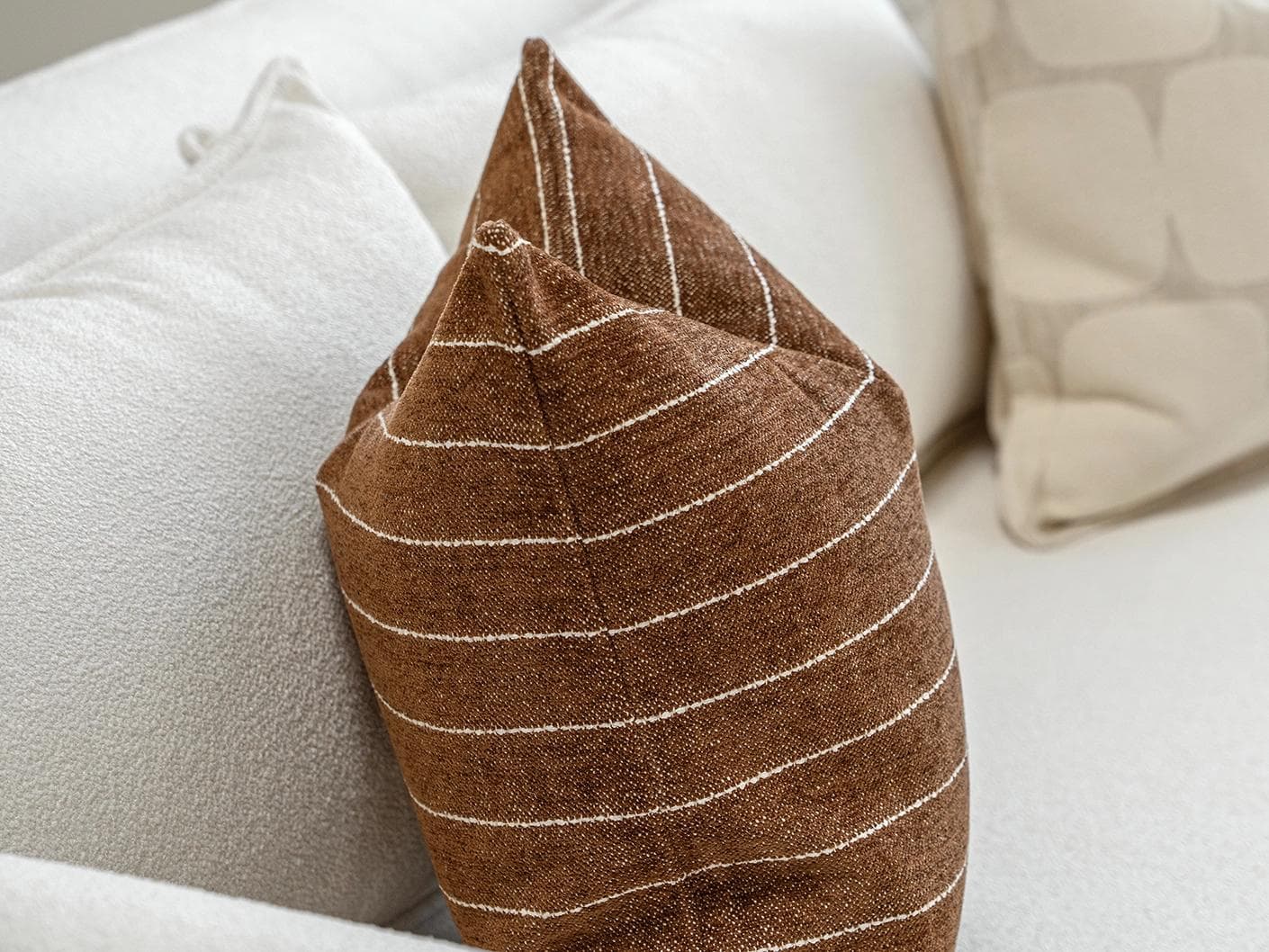 Rennie Bundle cushion in brown and white, shown in a product left view as image 6