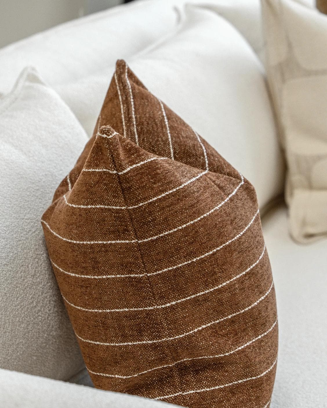 Rennie Bundle cushion in brown and white, shown in a product left view as image 6