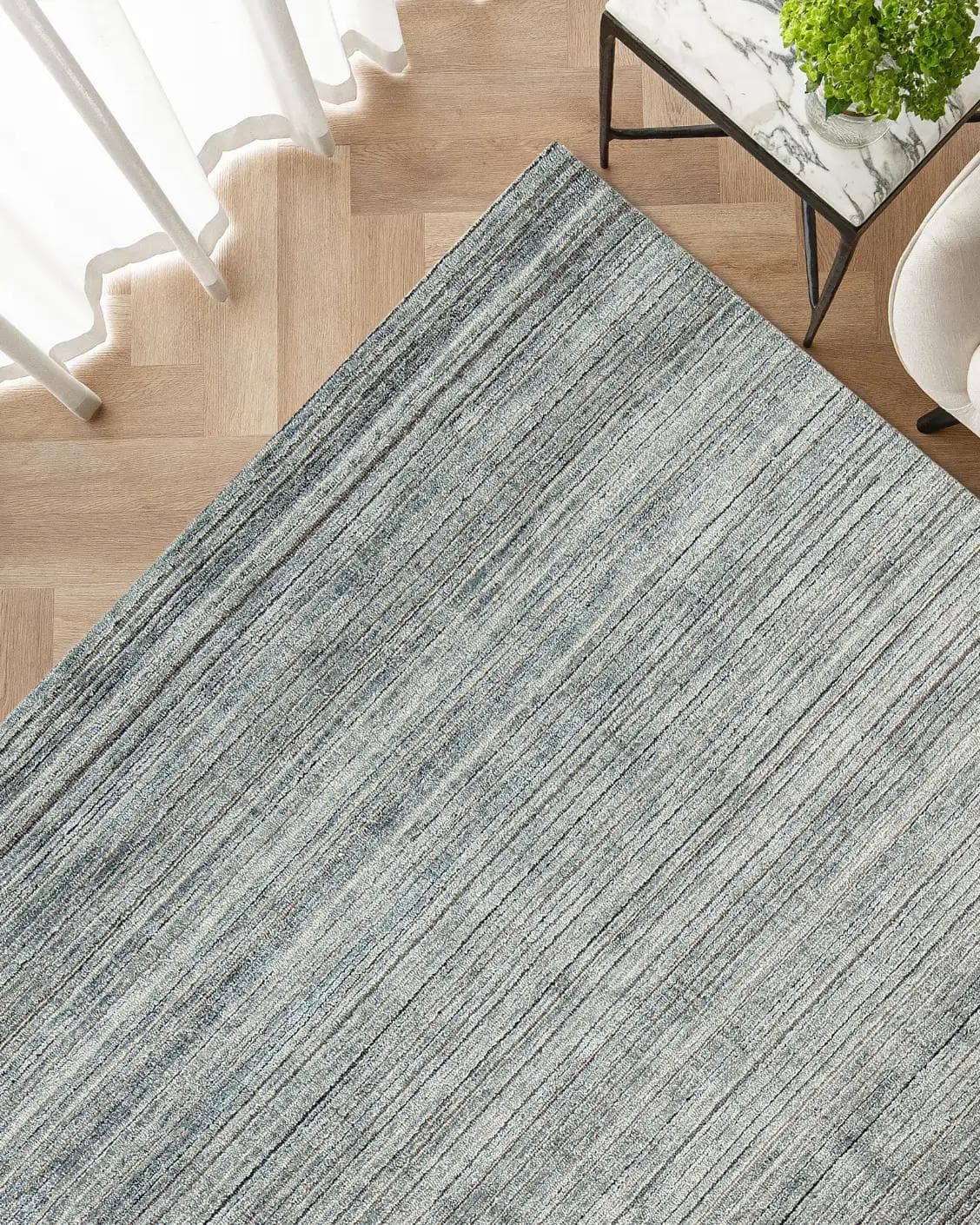 Rita Stevens carpet in grey, shown in a lifestyle top view as image 2