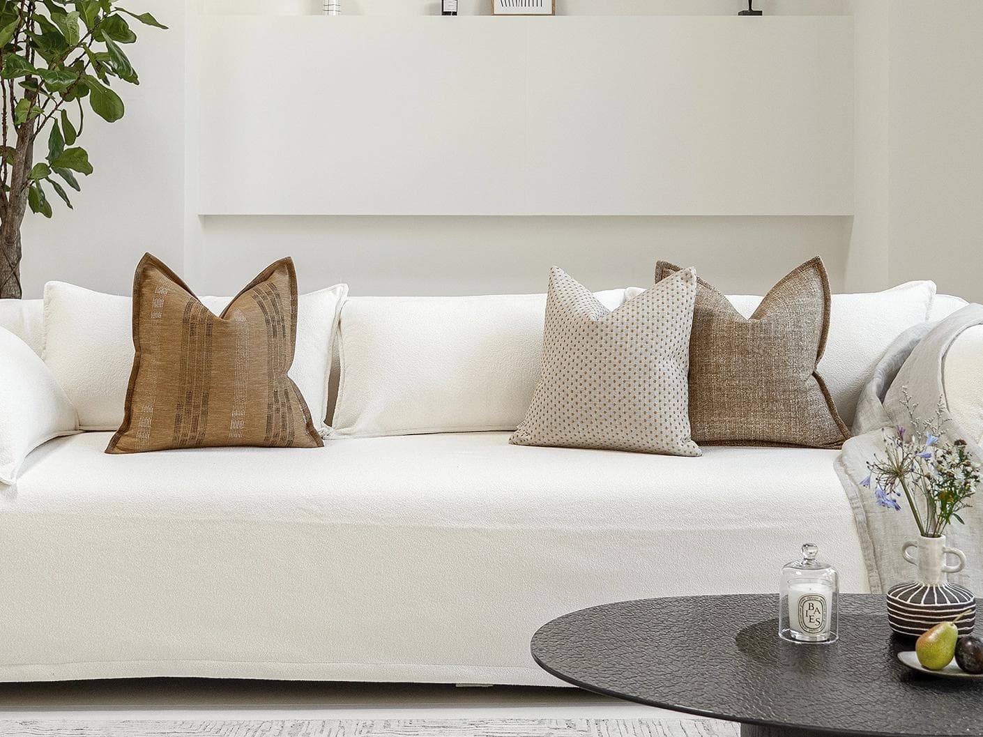 Romi Bundle cushion in brown and beige, shown in a lifestyle front view as image 4