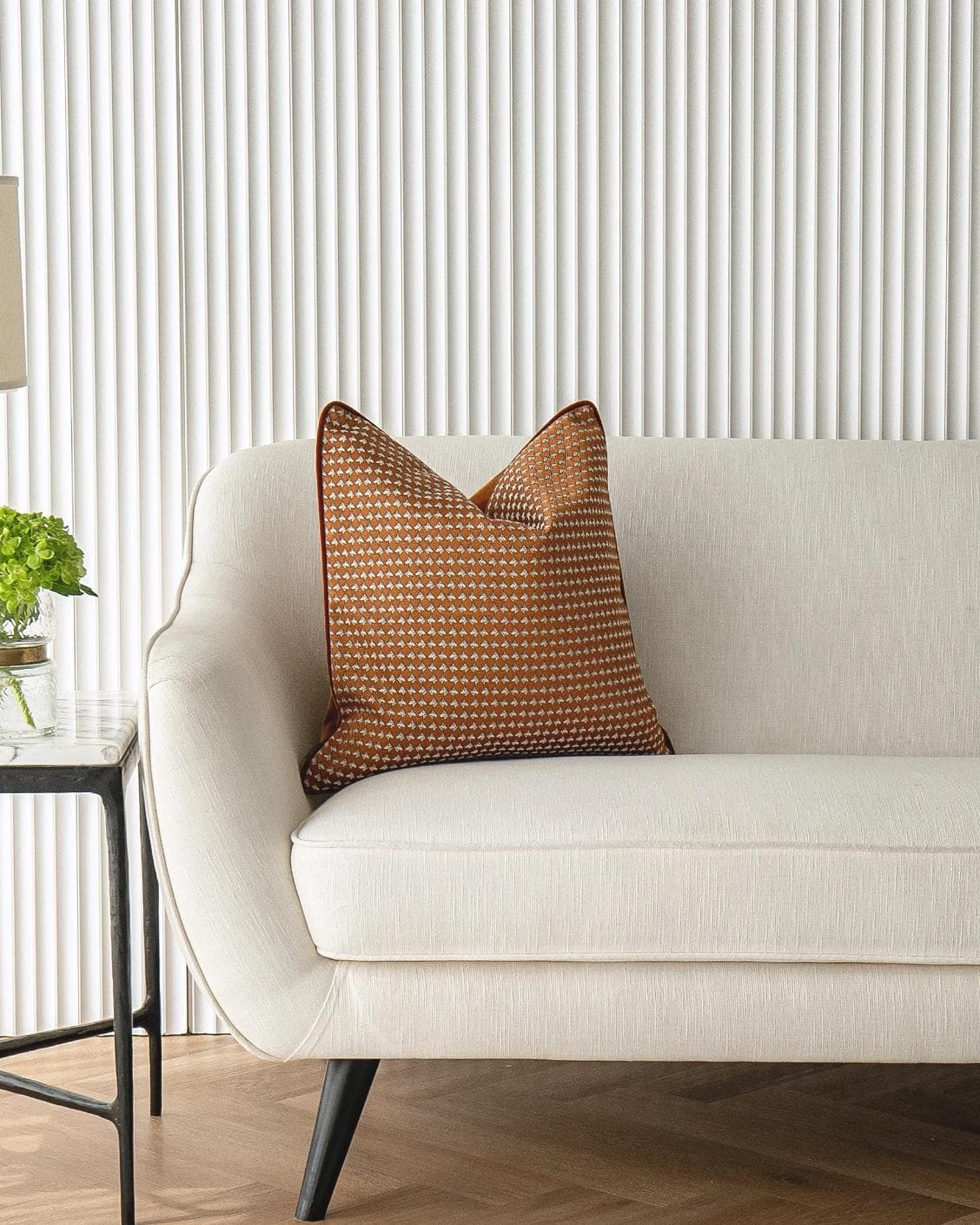 Rory Caravaggio cushion in orange, shown in a lifestyle front view as image 4
