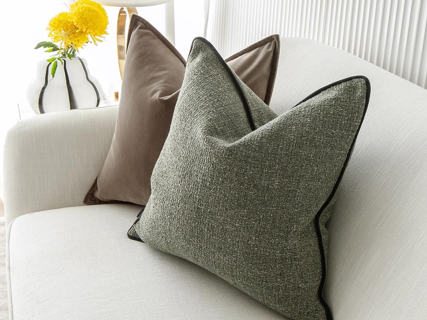 Roux Bundle cushion in orange, brown and green, shown in a lifestyle right view as image 5