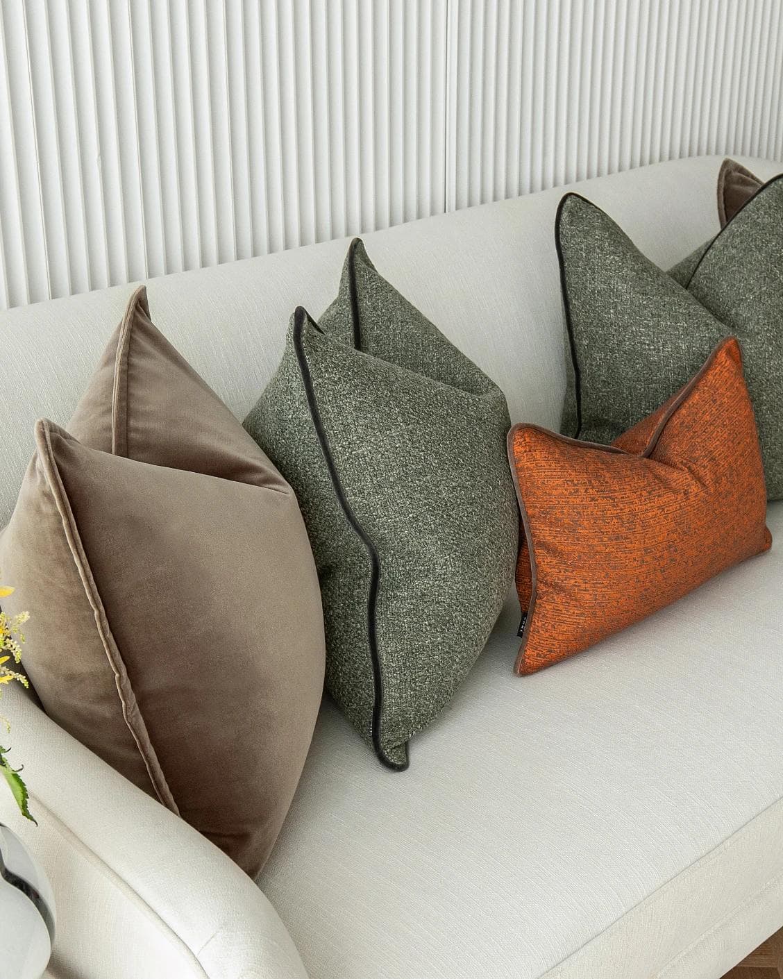 Roux Bundle cushion in orange, brown and green, shown in a product left view as image 6