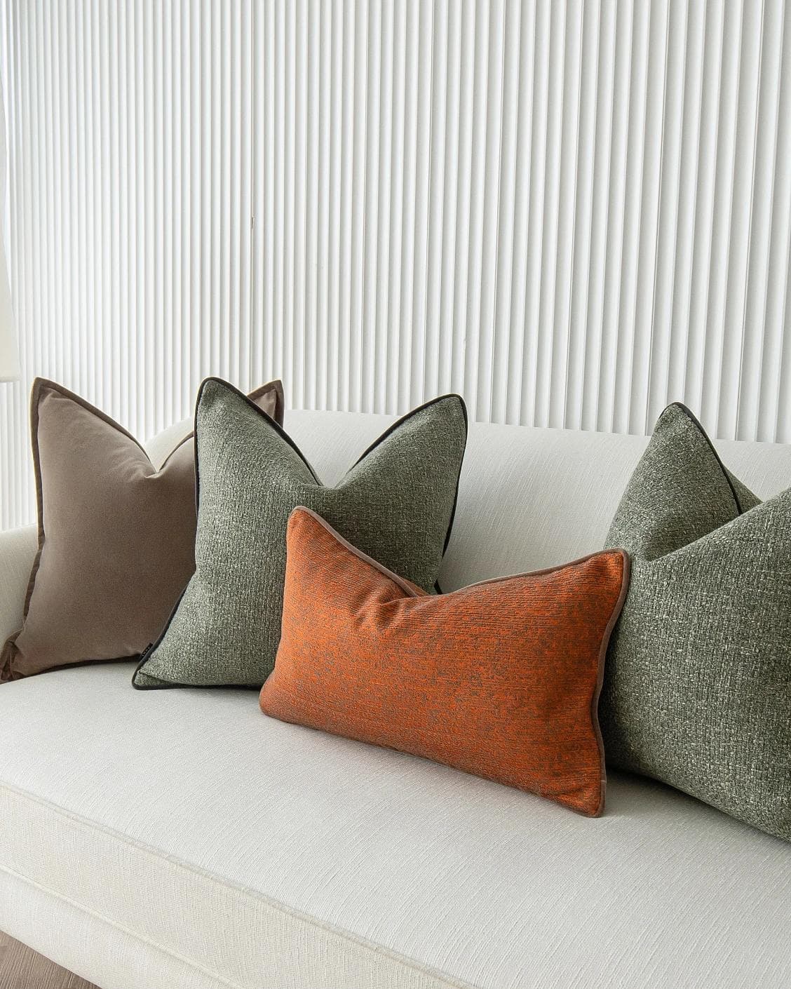 Roux Bundle cushion in orange, brown and green, shown in a product right view as image 7