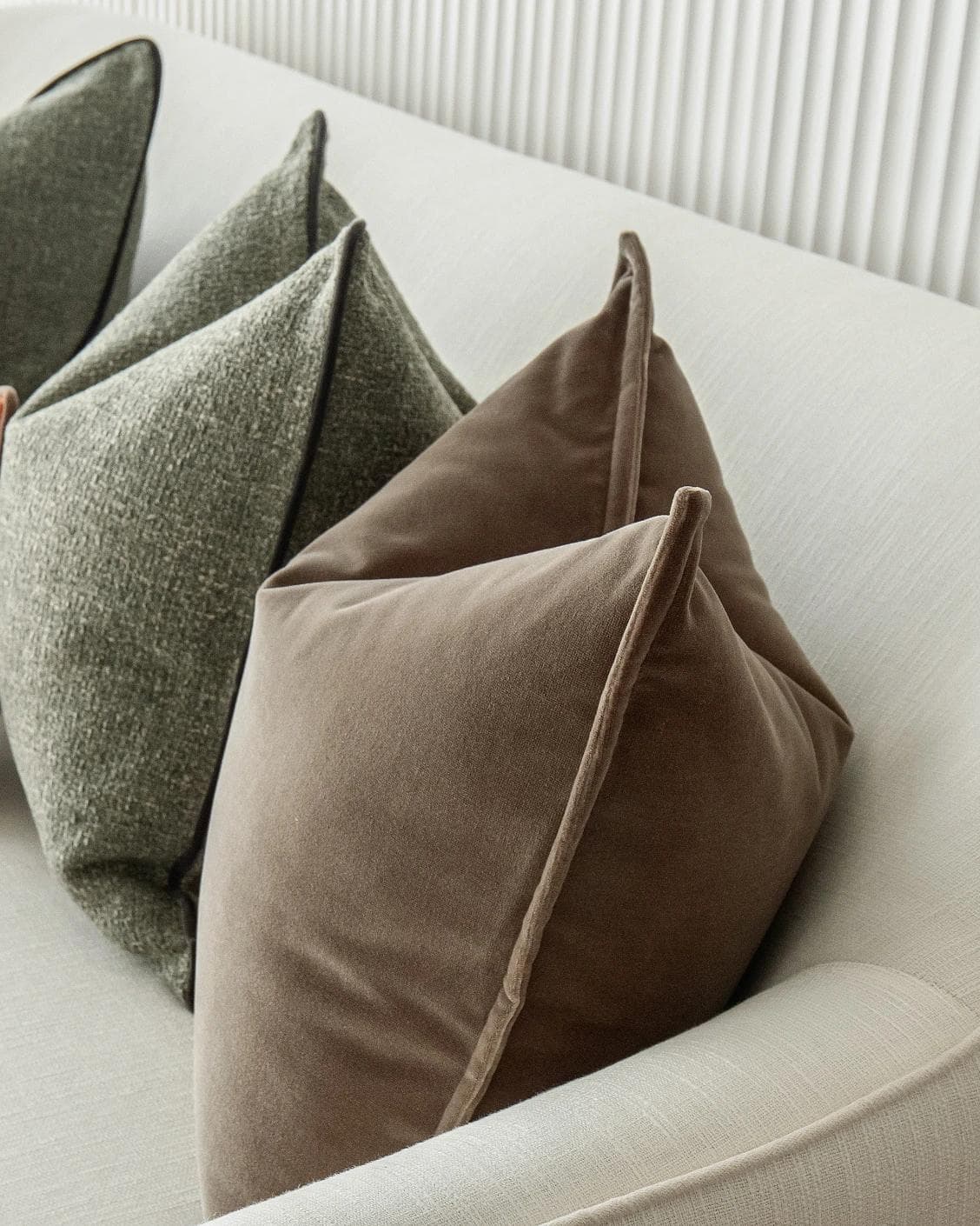 Roux Bundle cushion in orange, brown and green, shown in a product right view as image 8