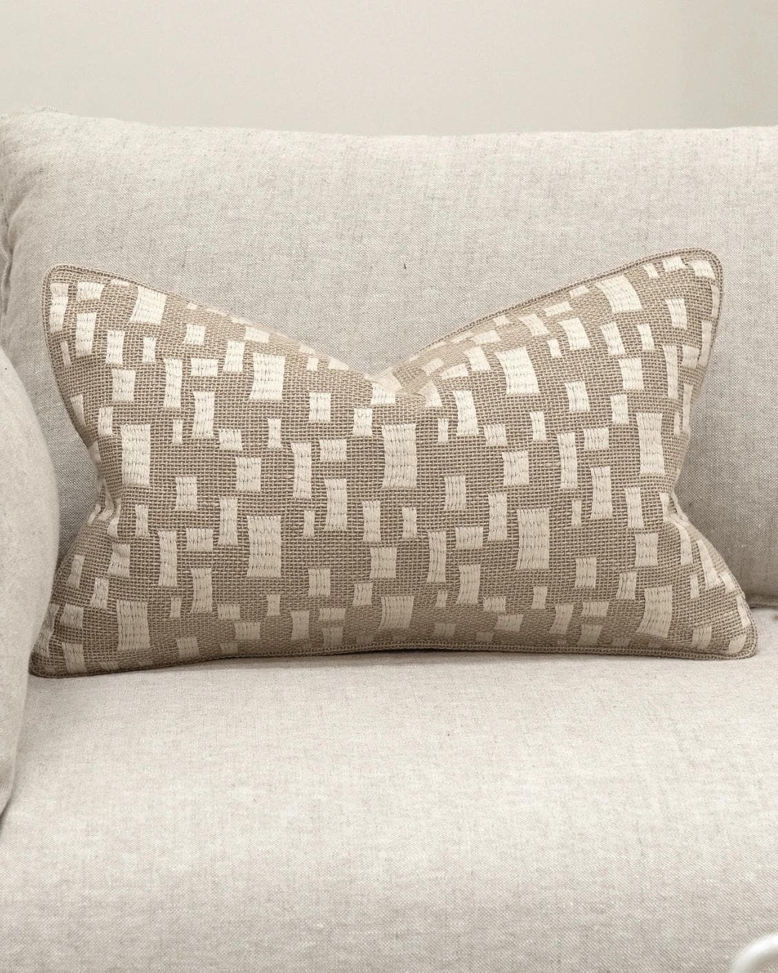 Ruth Laurent II cushion in beige and ivory, shown in a lifestyle front view as image 2