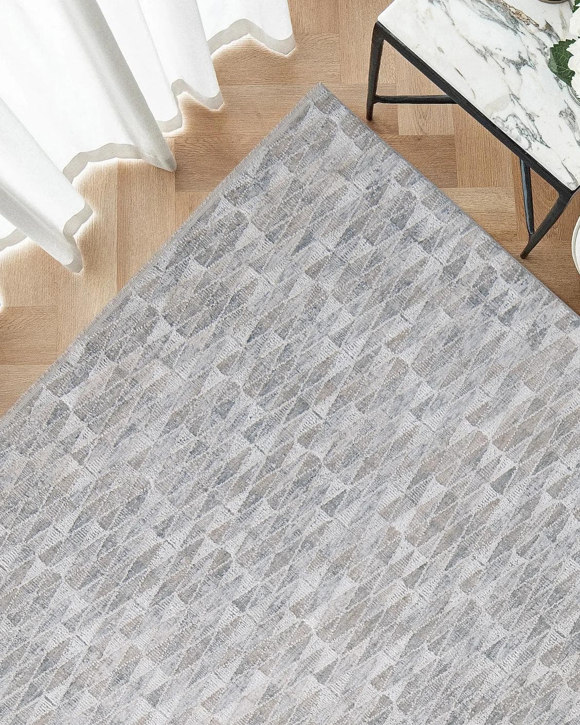 Savanna Sky carpet in blue, beige and grey, shown in a lifestyle top view as image 2