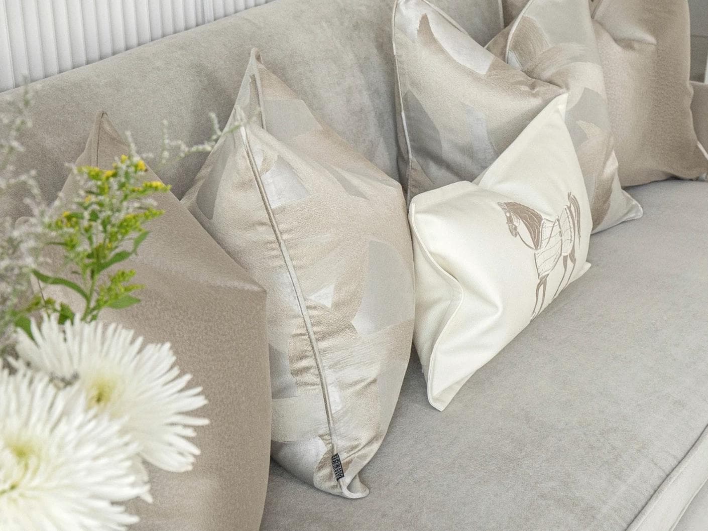 Issa Bundle cushion in gold, beige, silver and white, shown in a lifestyle left view as image 5
