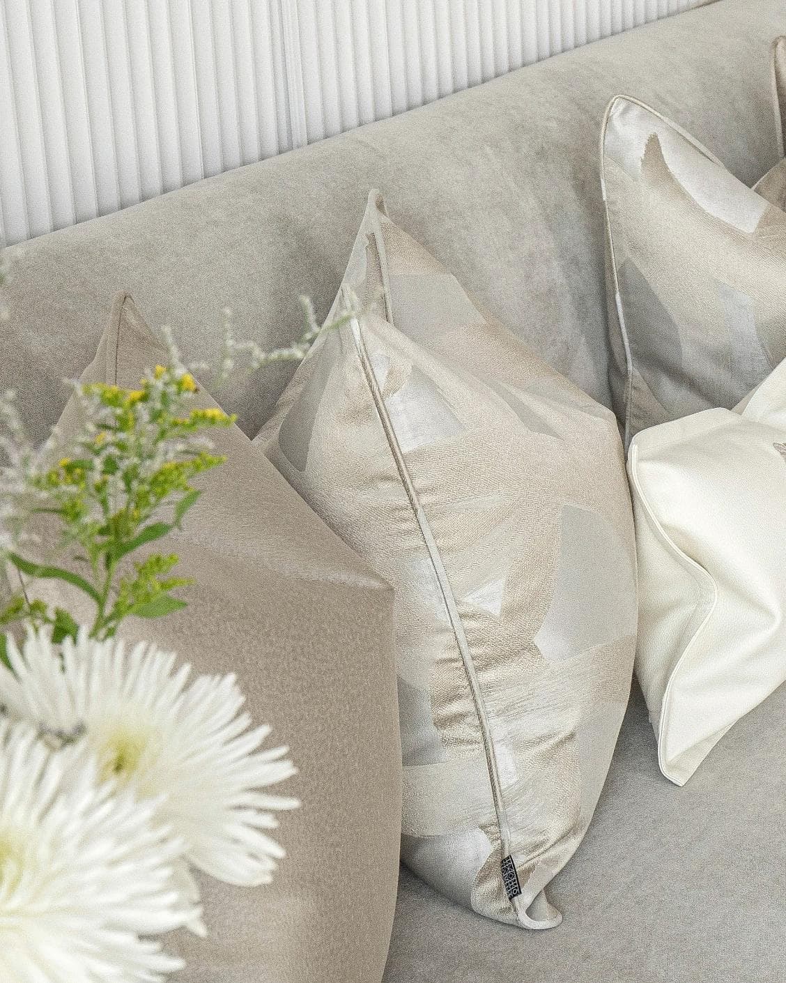 Issa Bundle cushion in gold, beige, silver and white, shown in a lifestyle left view as image 5