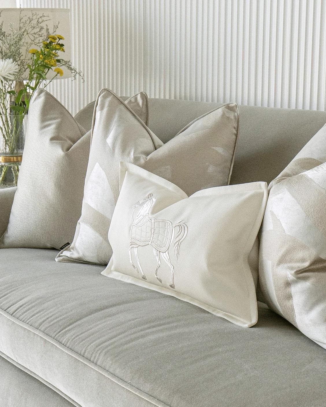 Issa Bundle cushion in gold, beige, silver and white, shown in a lifestyle right view as image 6