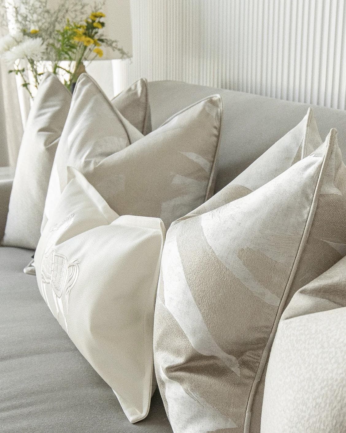 Issa Bundle cushion in gold, beige, silver and white, shown in a lifestyle right view as image 7