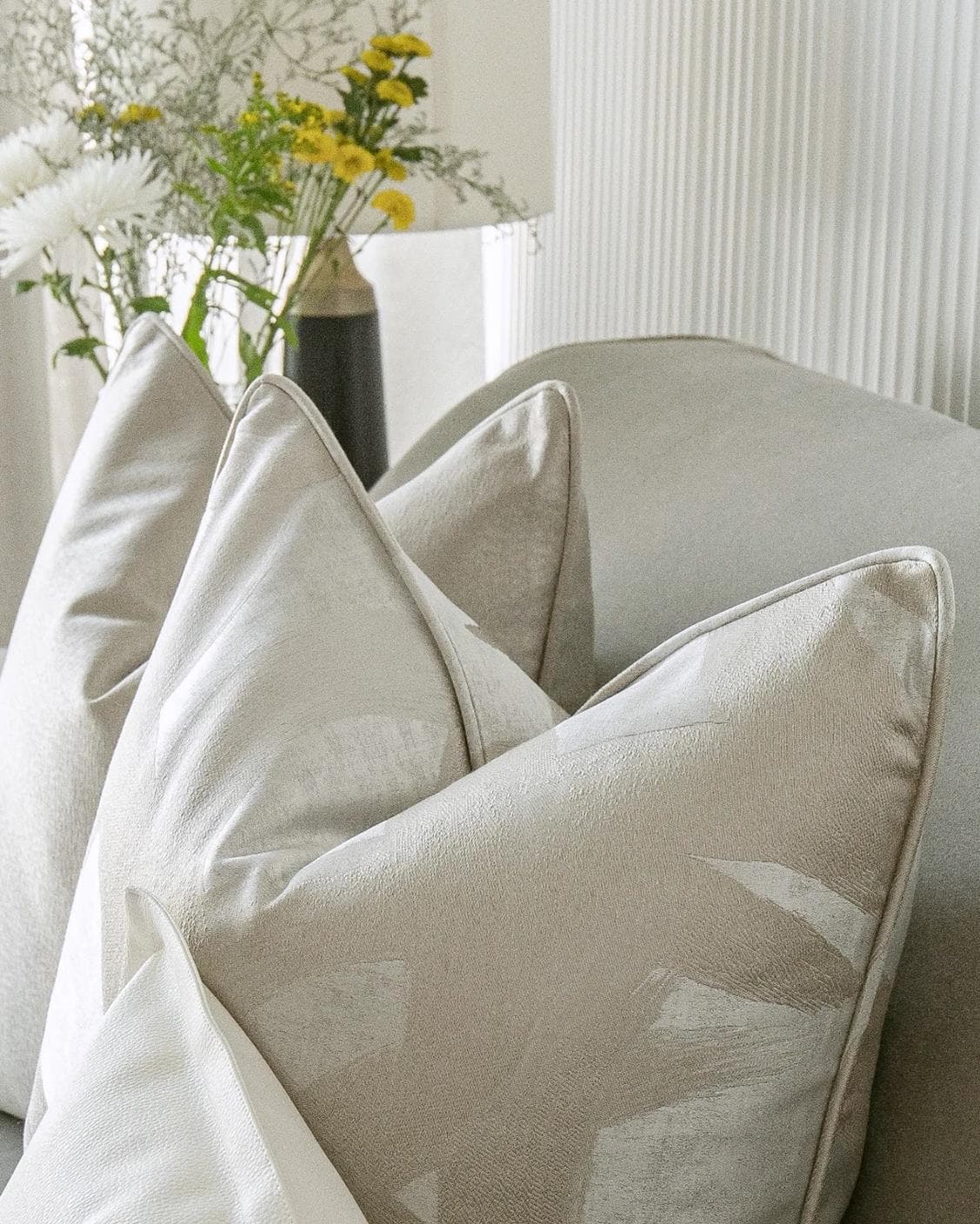 Issa Bundle cushion in gold, beige, silver and white, shown in a lifestyle top view as image 8
